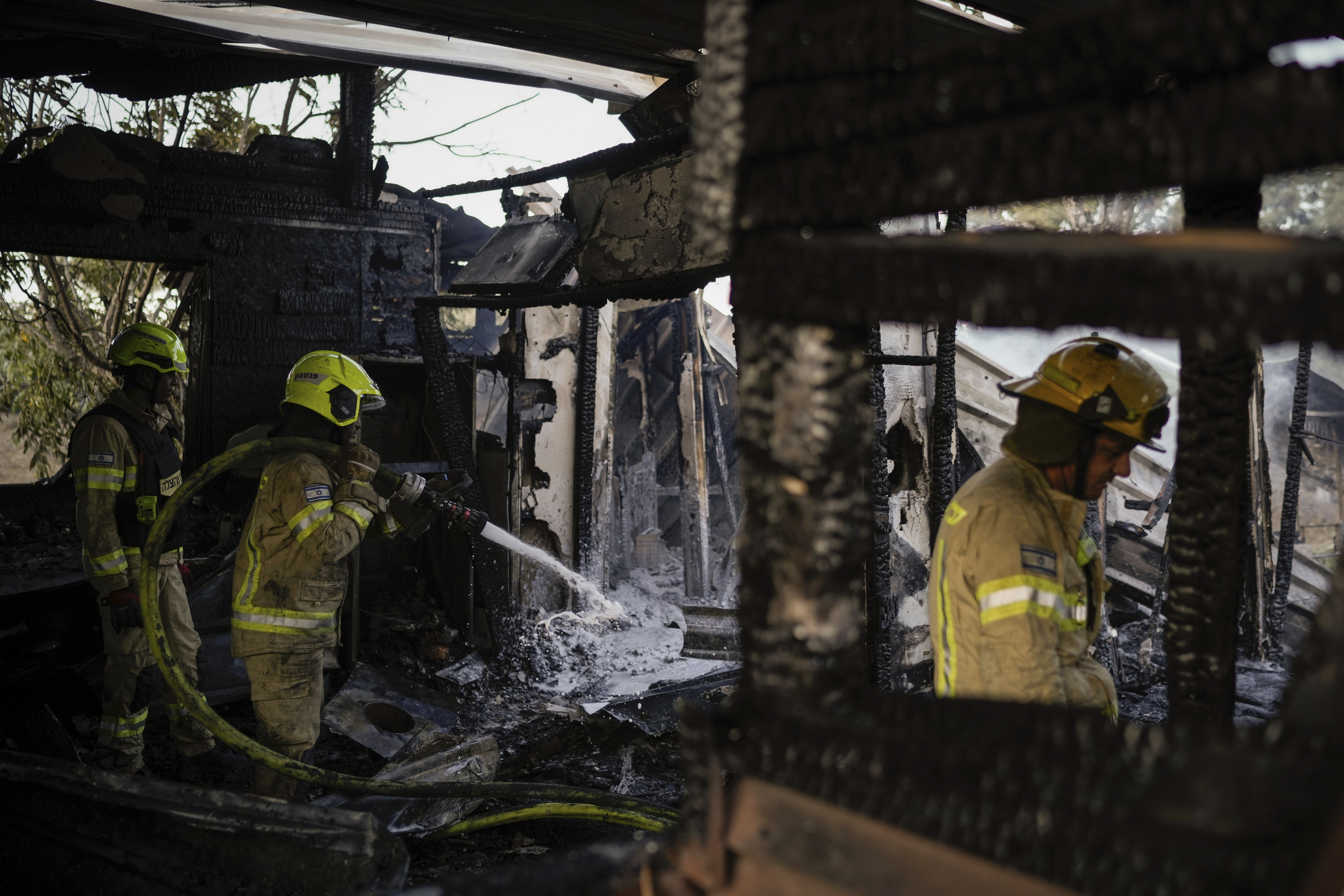 Israeli firefighters work at a house that was hit by a rocket fired from Lebanon, near the city of Safed, northern Israel, on Saturday, Sept. 21, 2024. (AP Photo//Leo Correa)