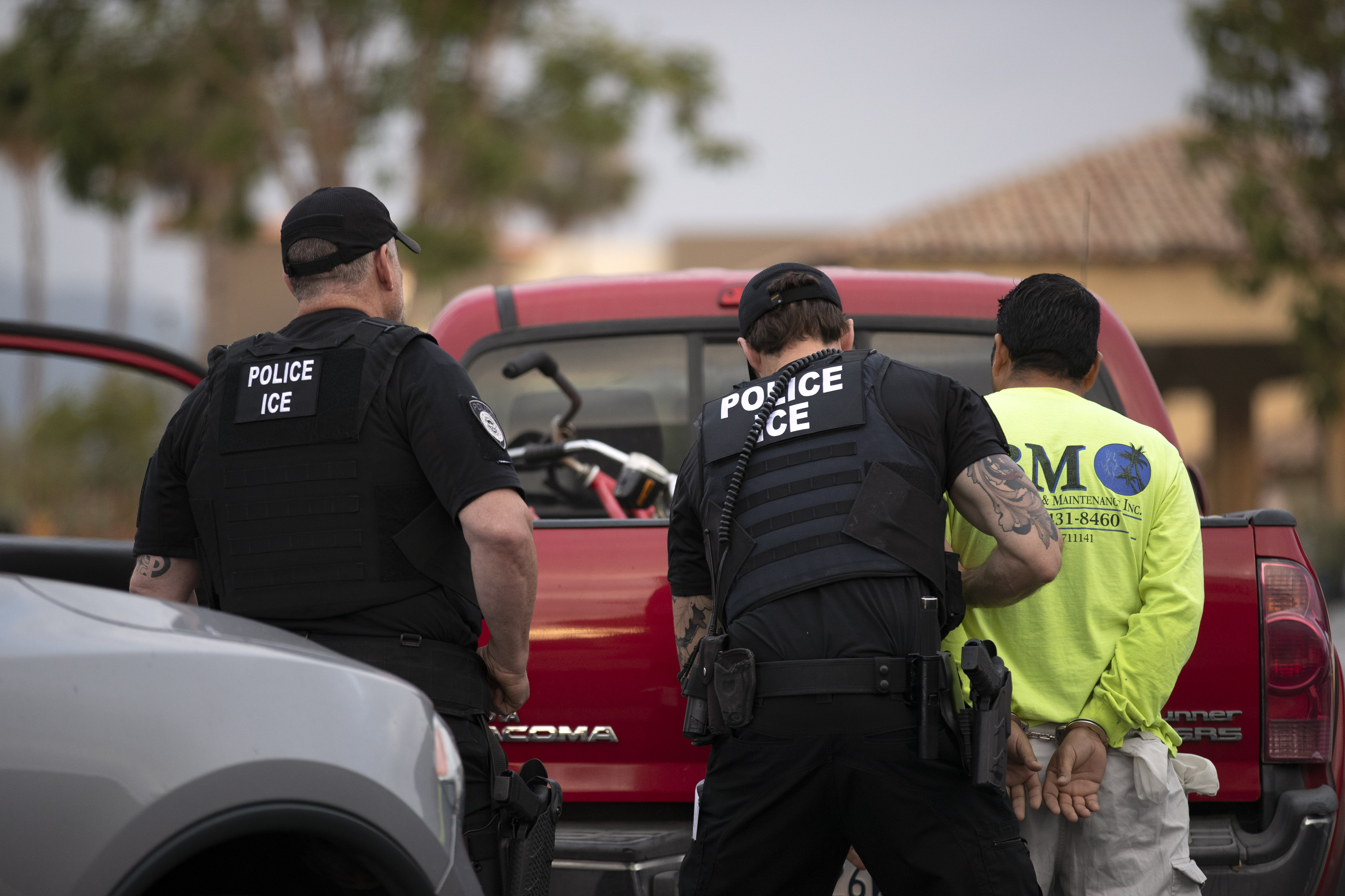 In this July 8, 2019, photo, a U.S. Immigration and Customs Enforcement (ICE) officers detain a man during an operation in Escondido, Calif. (AP Photo/Gregory Bull)