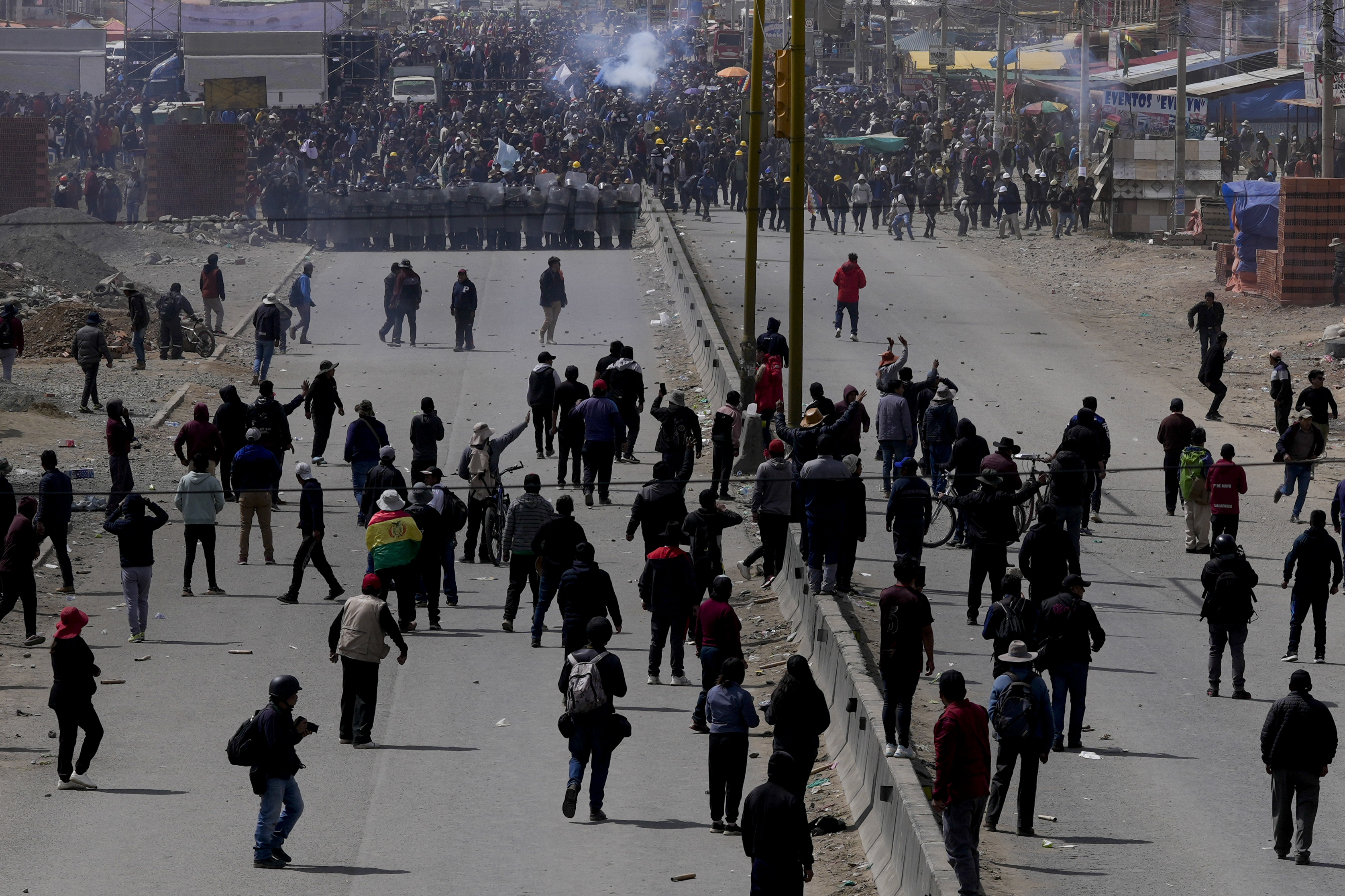 Supporters of former President Evo Morales, below, advance toward supporters of current president Luis Arce in El Alto, Bolivia, Sunday, Sept. 22, 2024. (AP Photo/Juan Karita)