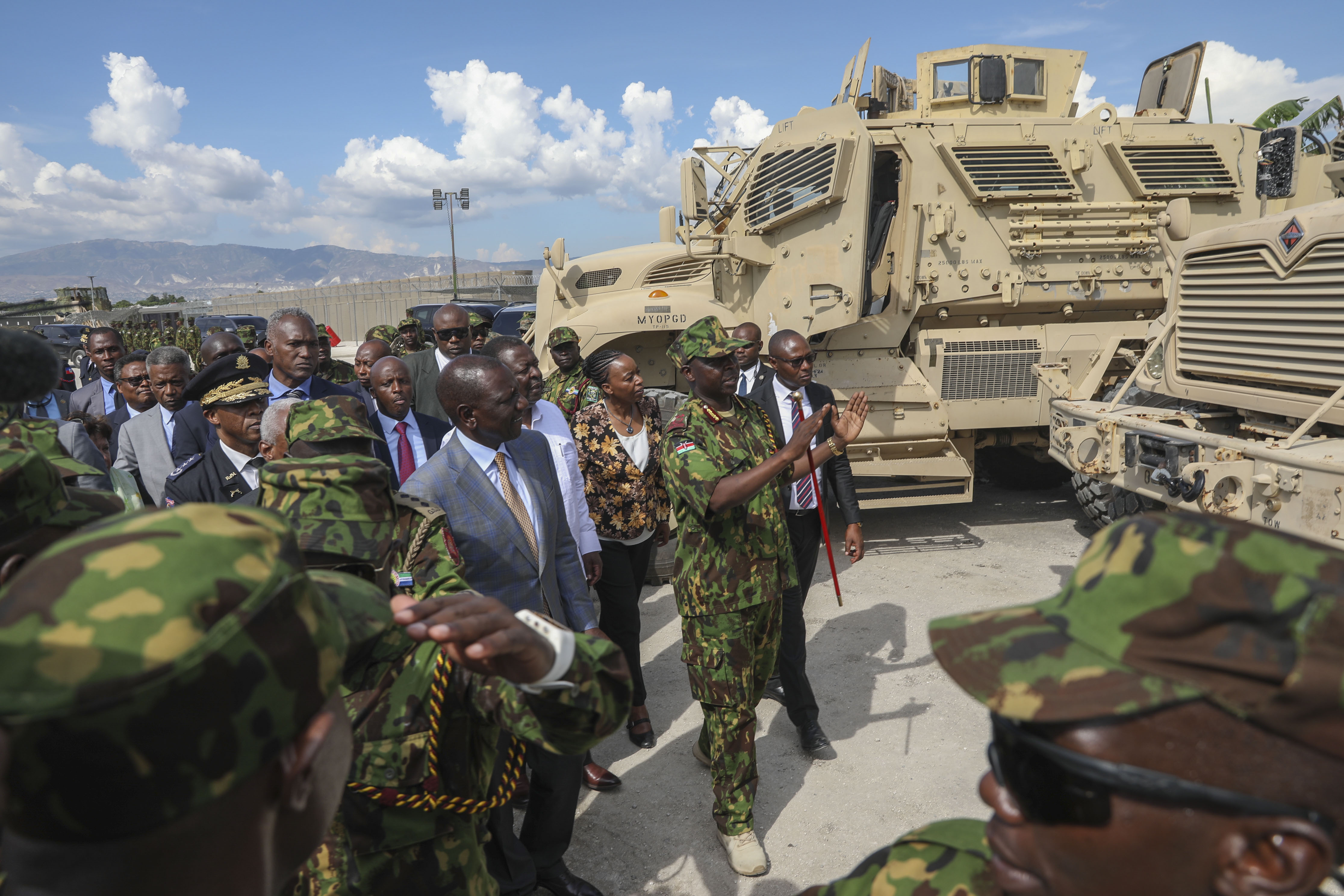 Kenya's President William Ruto, center left, visits Kenyan police, part of a UN-backed multinational force, at their base in Port-au-Prince, Haiti, Saturday, Sept. 21, 2024. (AP Photo/Odelyn Joseph)