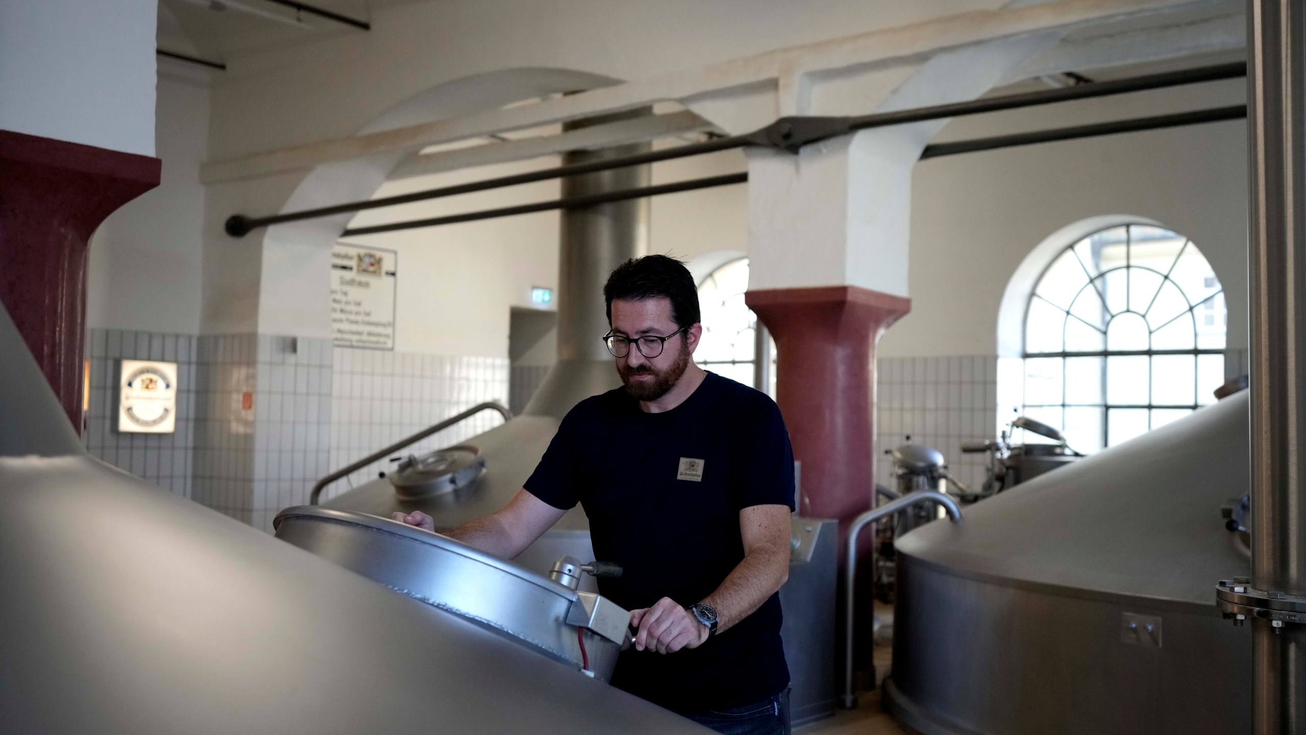 Head Brewmaster Tobias Zollo checks the output at the Weihenstephan brewery in Freising, Germany, Friday, Sept. 20, 2024. (AP Photo/Matthias Schrader)