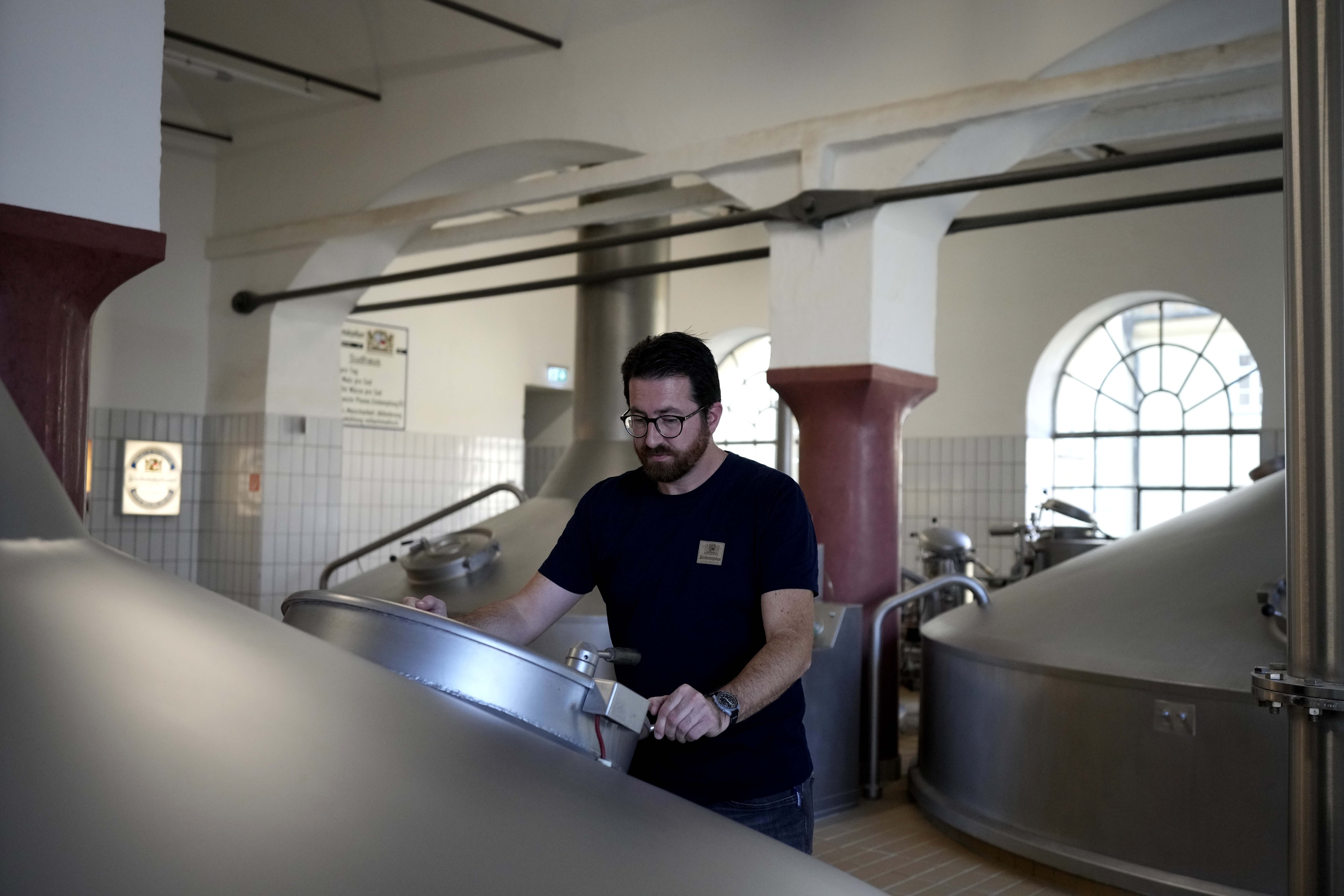 Head Brewmaster Tobias Zollo checks the output at the Weihenstephan brewery in Freising, Germany, Friday, Sept. 20, 2024. (AP Photo/Matthias Schrader)