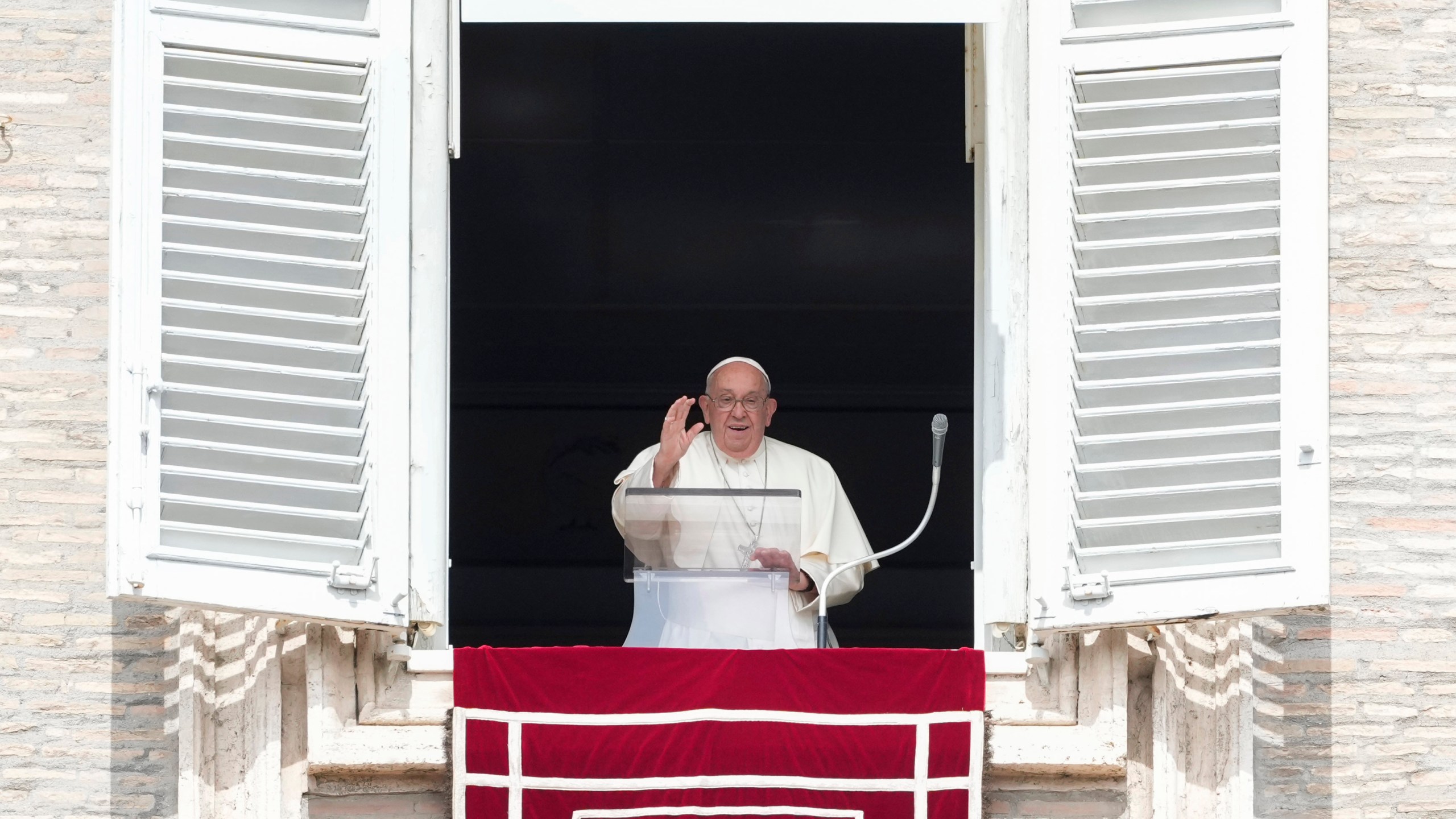 Pope Francis waves during the Angelus noon prayer from the window of his studio overlooking St.Peter's Square, at the Vatican, Sunday, Sept. 22, 2024. (AP Photo/Alessandra Tarantino)