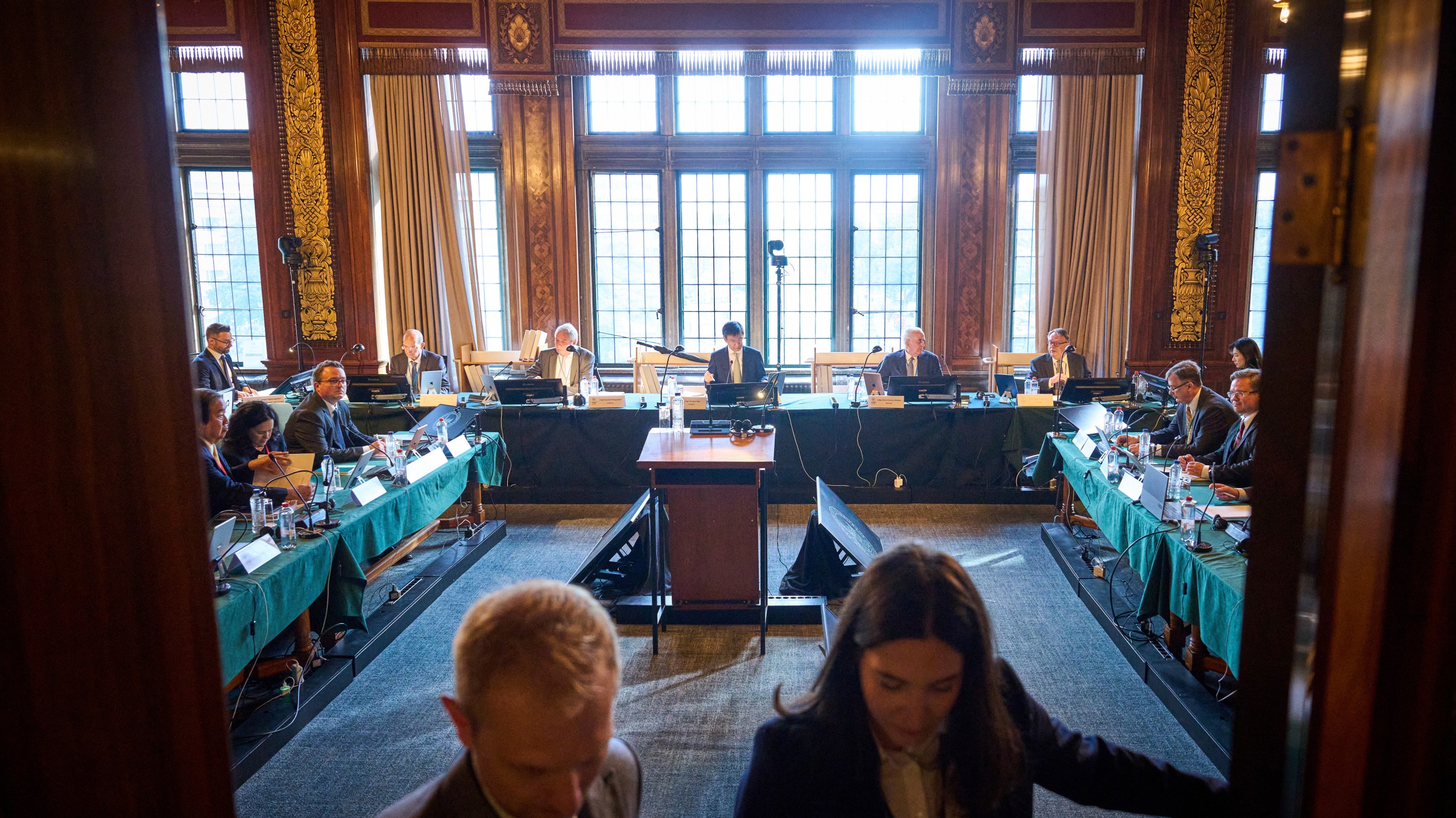 The delegations of Ukraine and Russia attend the start of PCA Case between Ukraine and the Russian Federation in the Netherlands, Monday, Sept. 23, 2024. (AP Photo/Phil Nijhuis)