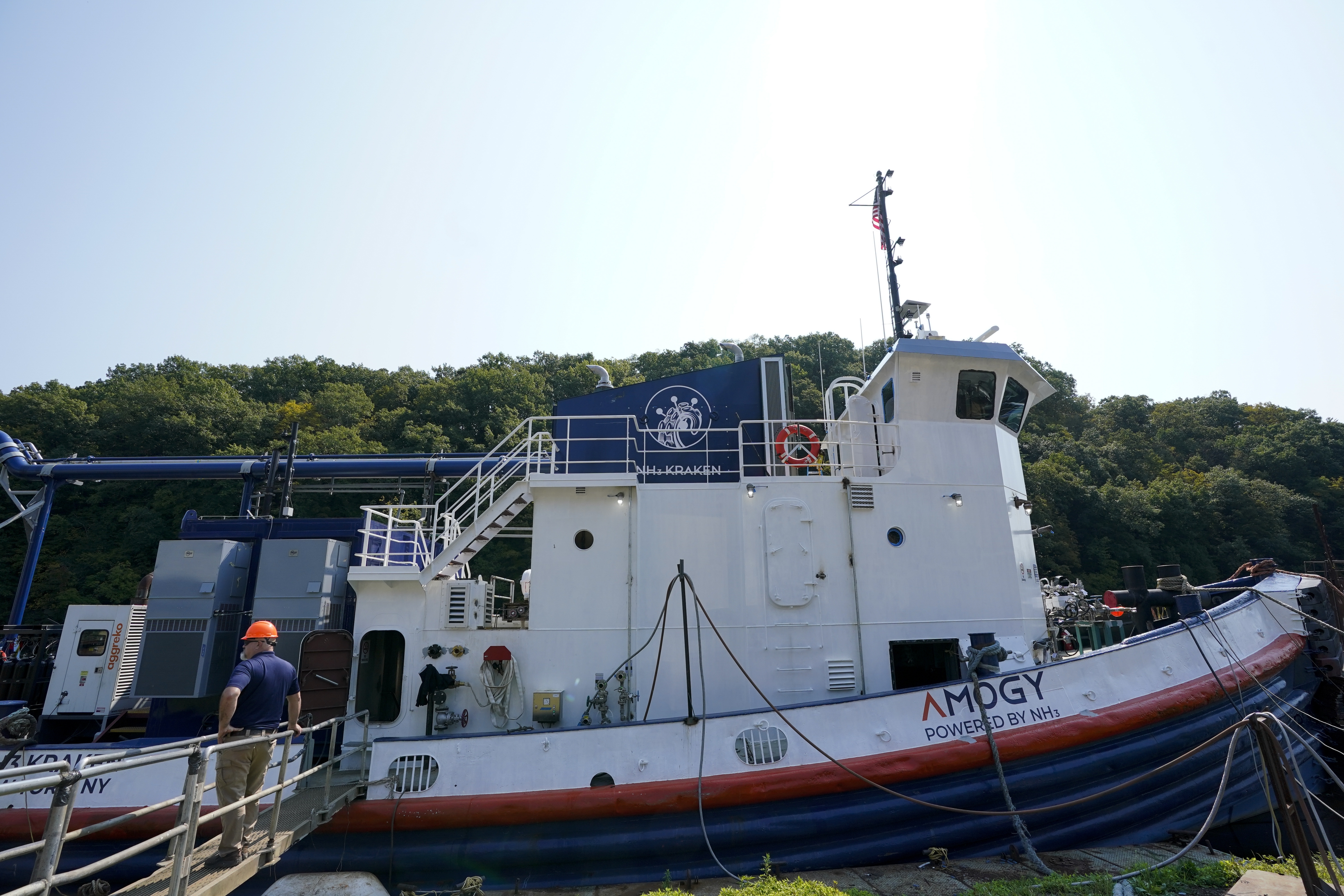 A worker stands near the NH3 Kraken, a tugboat powered by ammonia, on Friday, Sept. 13, 2024, in Kingston, N.Y. (AP Photo/Alyssa Goodman)