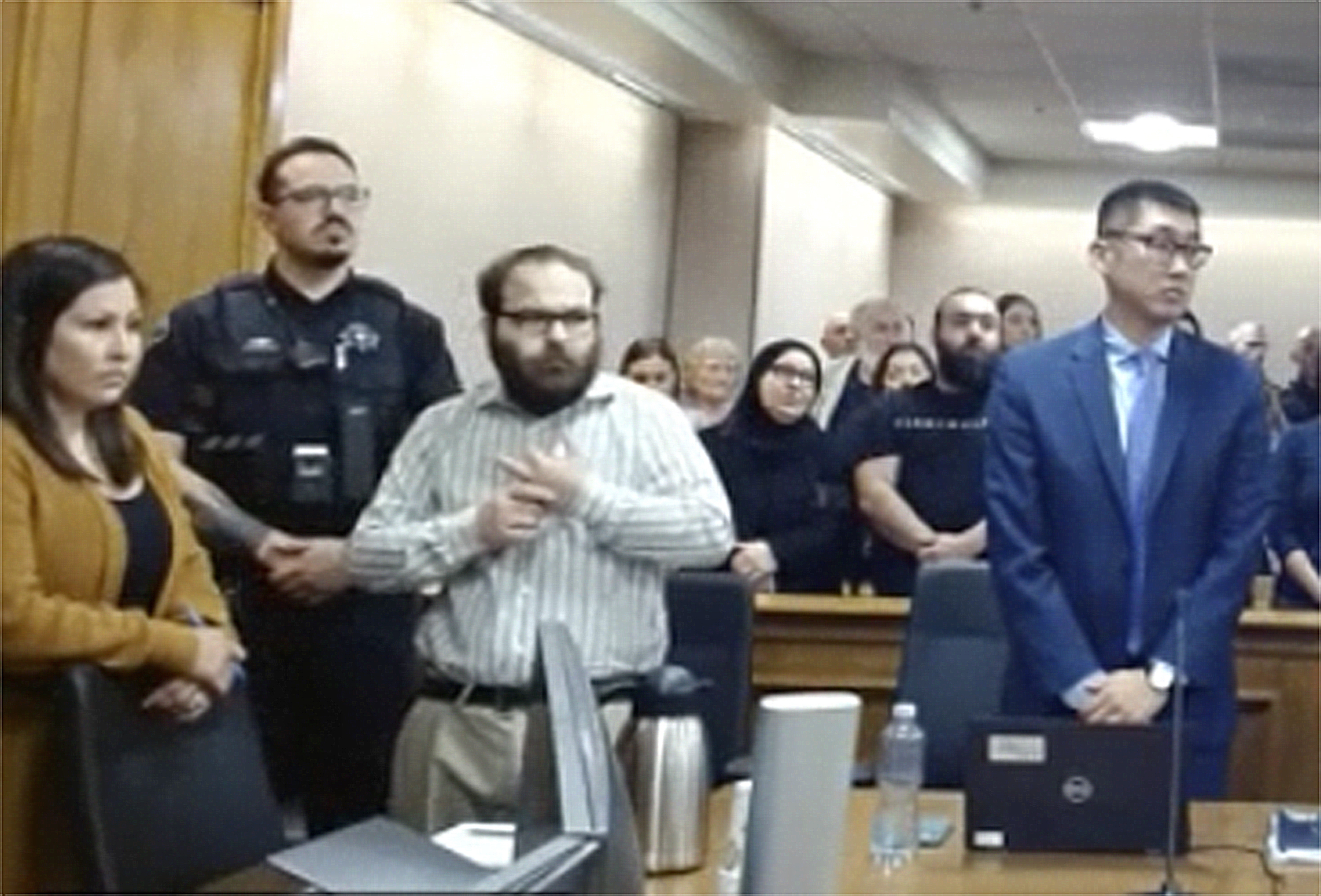 In this image taken from video provided by the Colorado Judicial Branch, Ahmad Alissa, third from left, stands for the verdict in his trial for the 2021 Colorado supermarket shootings, Monday, Sept 23, 2024, in Boulder, Colo. (Colorado Judicial Branch via AP)