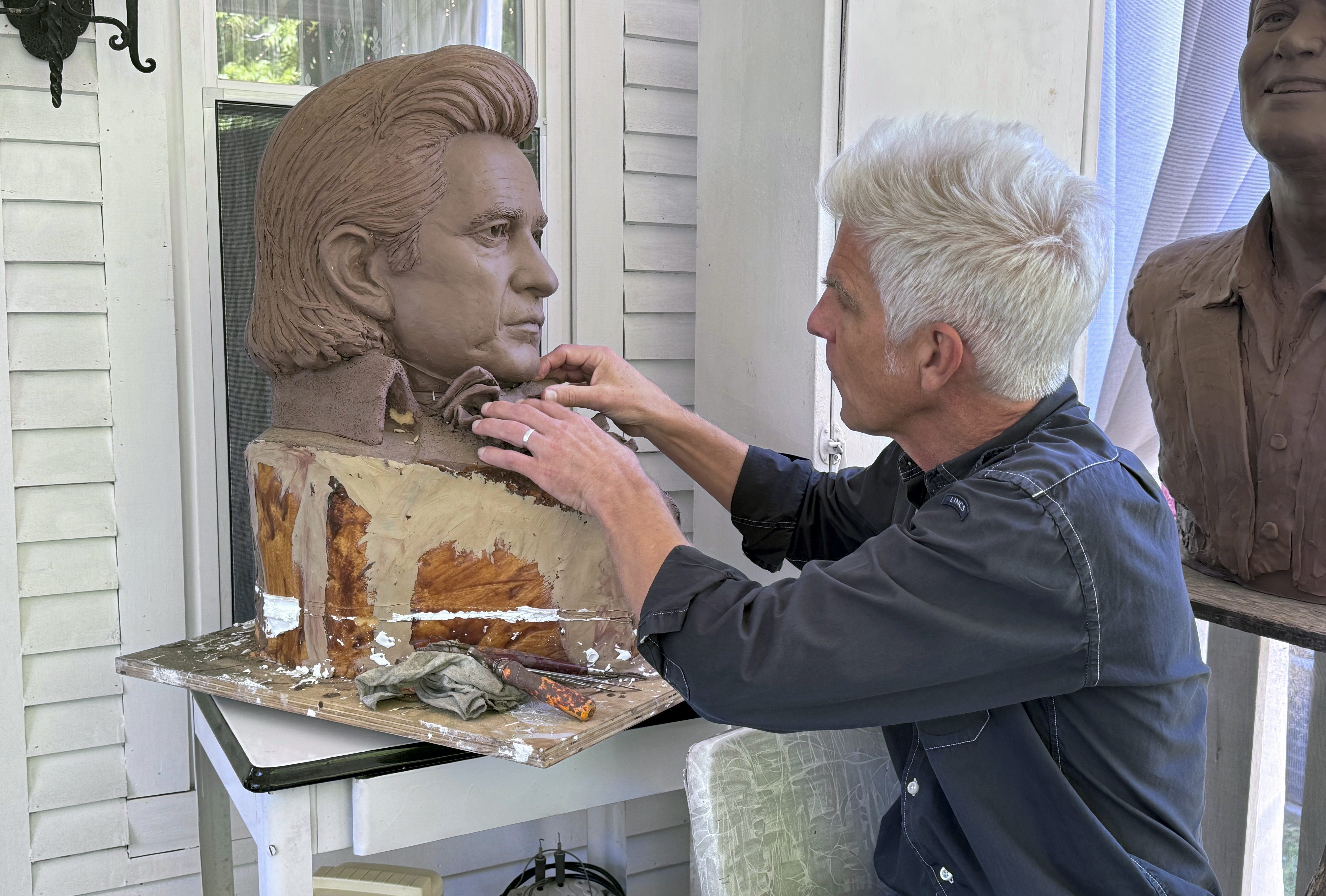 FILE - Artist Kevin Kresse, works on a clay bust of Johnny Cash, April 23, 2024 in Little Rock, Ark. Kresse's full sculpture of Cash will be unveiled at the U.S. Capitol as part of the Statuary Hall collection. (AP Photo/Mike Pesoli, File)