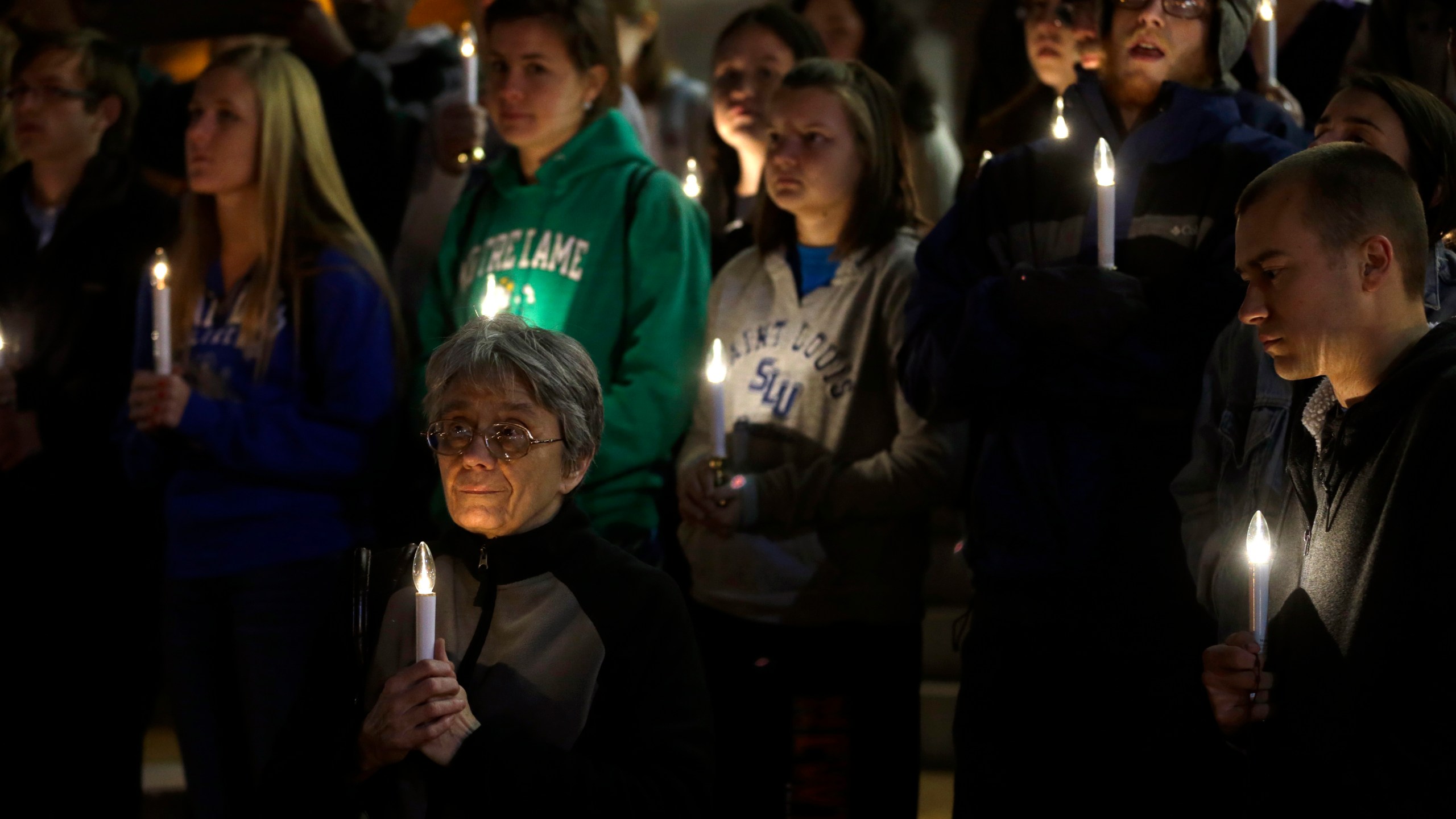 FILE - In this Nov. 19, 2013 file photo, a small group of death penalty opponents stand outside St. Francis Xavier Church during a vigil in protest of the scheduled execution of Missouri death row inmate Joseph Paul Franklin in St. Louis. (AP Photo/Jeff Roberson, File)