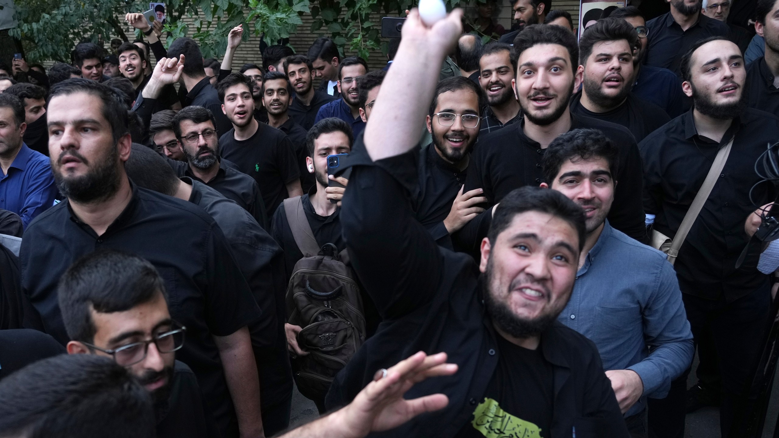 FILE -A demonstrator throws an egg at the Swedish Embassy during a protest for the desecration of the Quran in Sweden, July 21, 2023, in Tehran, Iran. (AP Photo/Vahid Salemi, File)