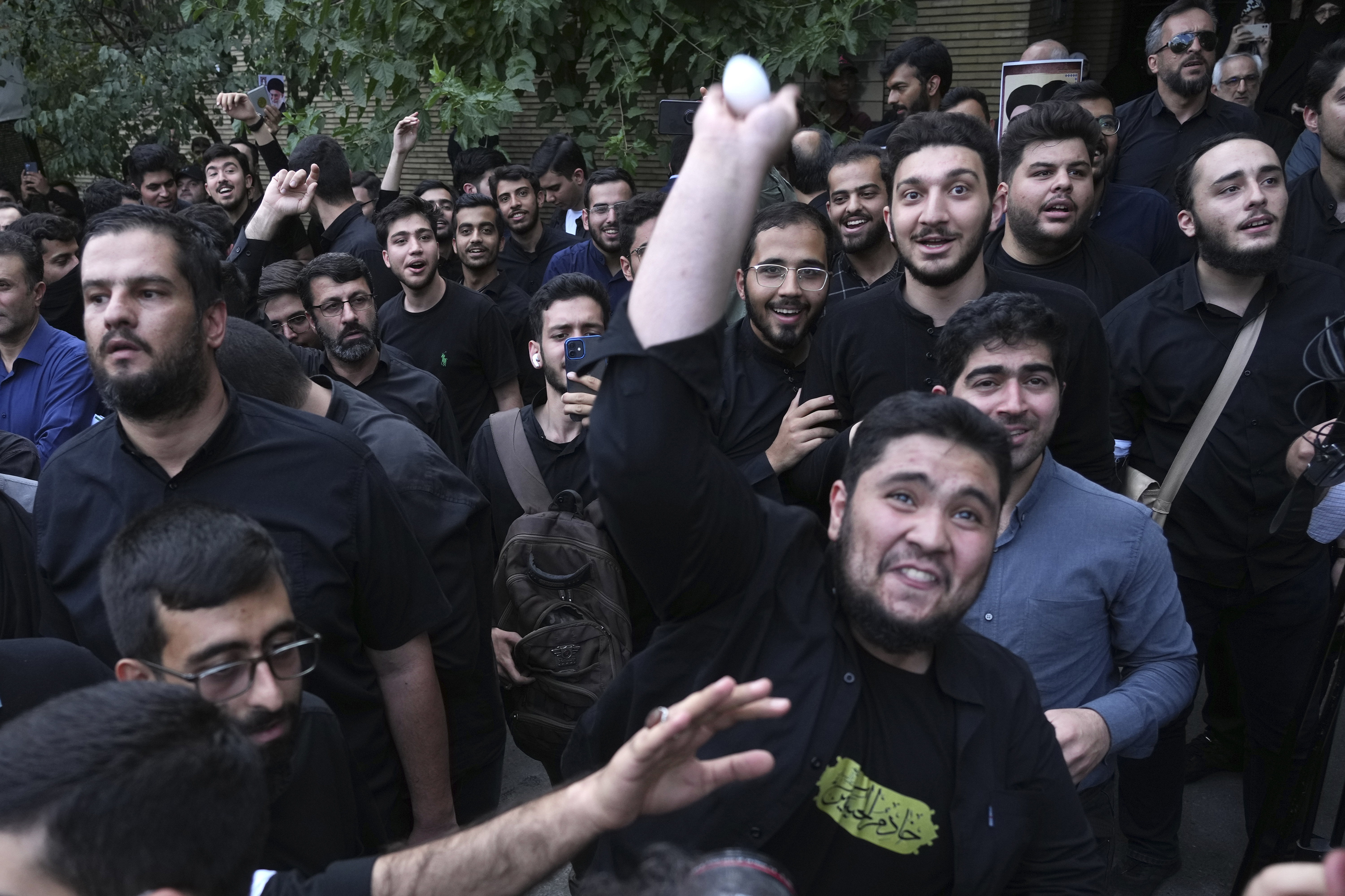 FILE -A demonstrator throws an egg at the Swedish Embassy during a protest for the desecration of the Quran in Sweden, July 21, 2023, in Tehran, Iran. (AP Photo/Vahid Salemi, File)