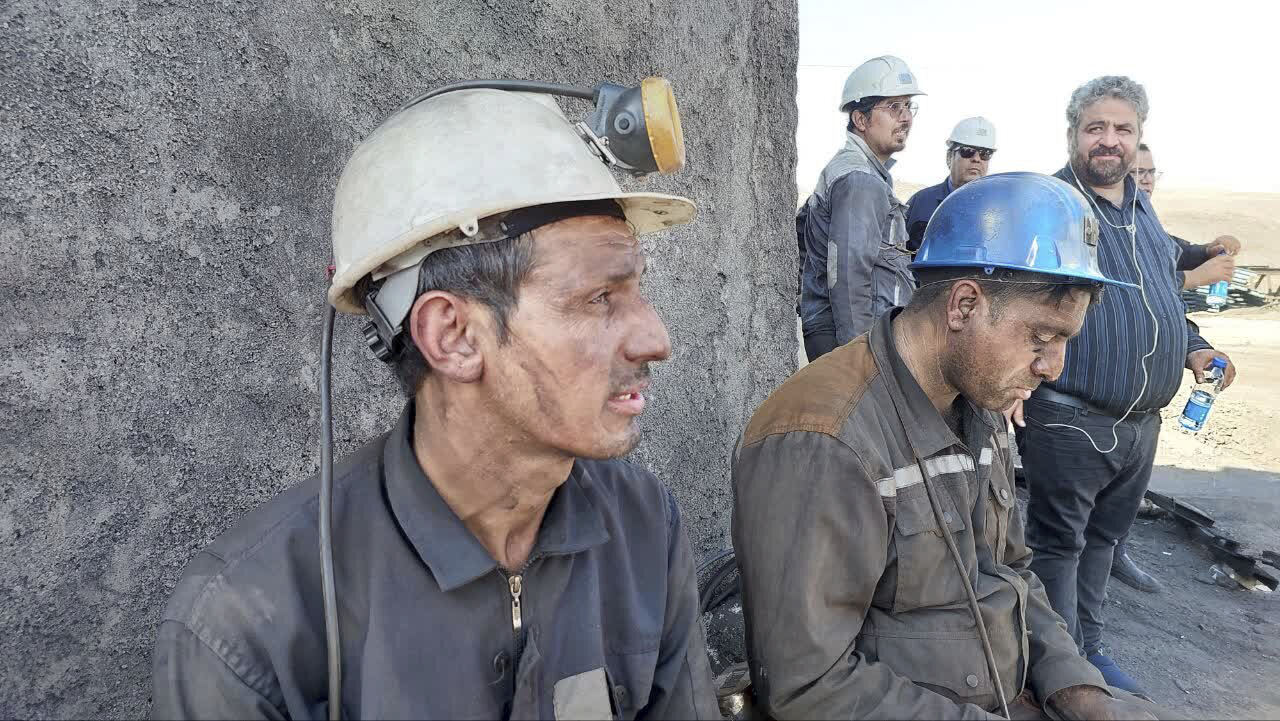 In this photo released on Tuesday, Sept. 24, 2024, by Iranian Interior Ministry, miners sit at the site of a coal mine where methane leak sparked an explosion on Saturday, in Tabas, some 335 miles (540 kilometers) southeast of the capital Tehran, Iran. (Iranian Interior Ministry via AP)