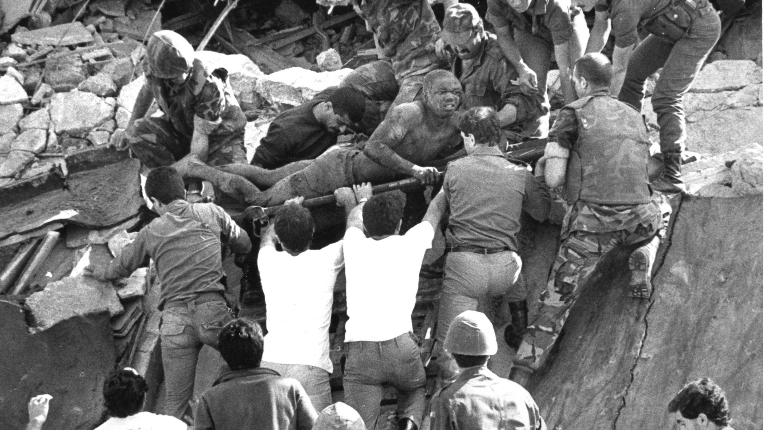 FILE - British soldiers give a hand in rescue operations at the site of the bomb-wrecked U.S. Marine command center near Beirut airport on Oct. 23, 1983. (AP Photo/Bill Foley/File)