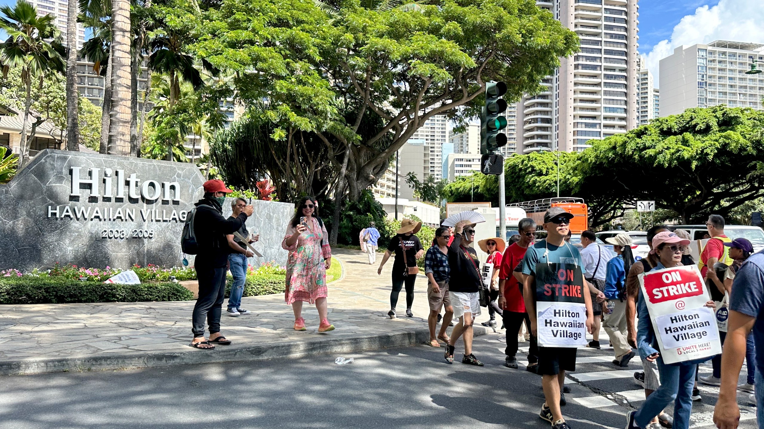 Hotel workers march outside the Hilton Hawaiian Village resort after going on strike on Tuesday, Sept. 24, 2024, in Honolulu. (AP Photo/Jennifer Sinco Kelleher)