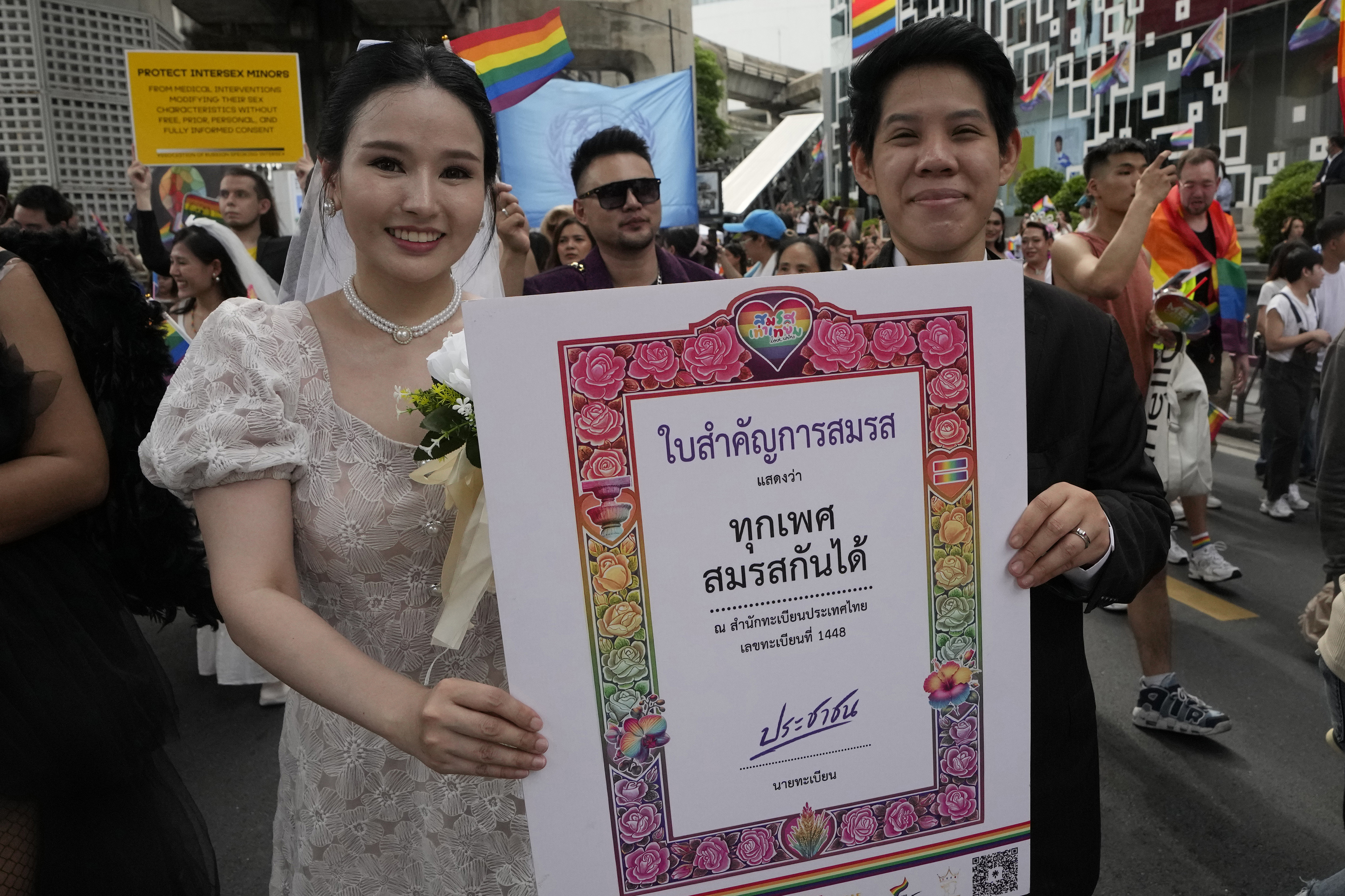 FILE - Participants hold posters celebrating equality in marriage during the Pride Parade in Bangkok, Thailand, Saturday, June 1, 2024. (AP Photo/Sakchai Lalit, File)