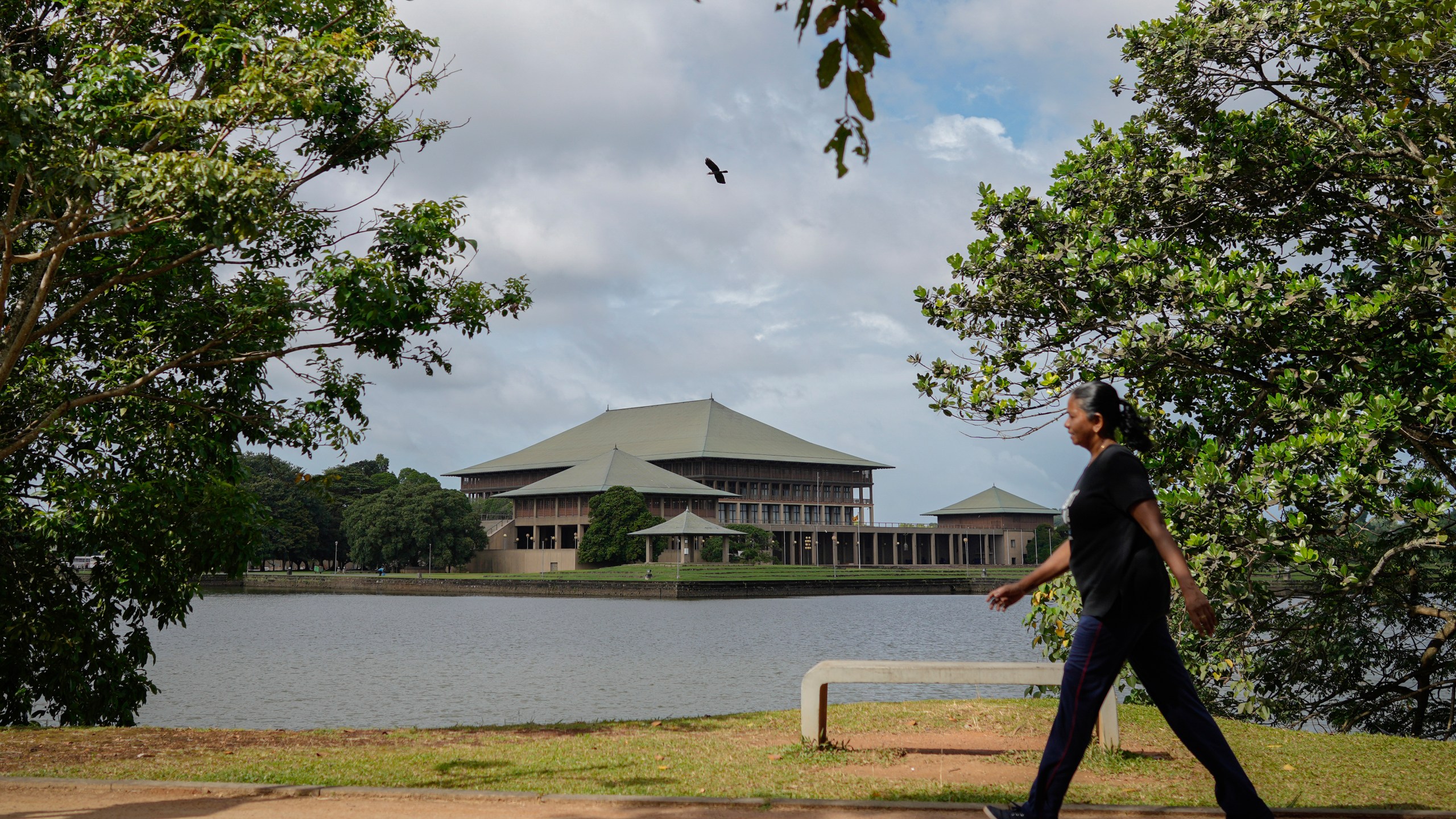 A woman walks outside the parliamentary complex in Colombo, Sri Lanka, Wednesday, Sept. 25, 2024. (AP Photo/Eranga Jayawardena)