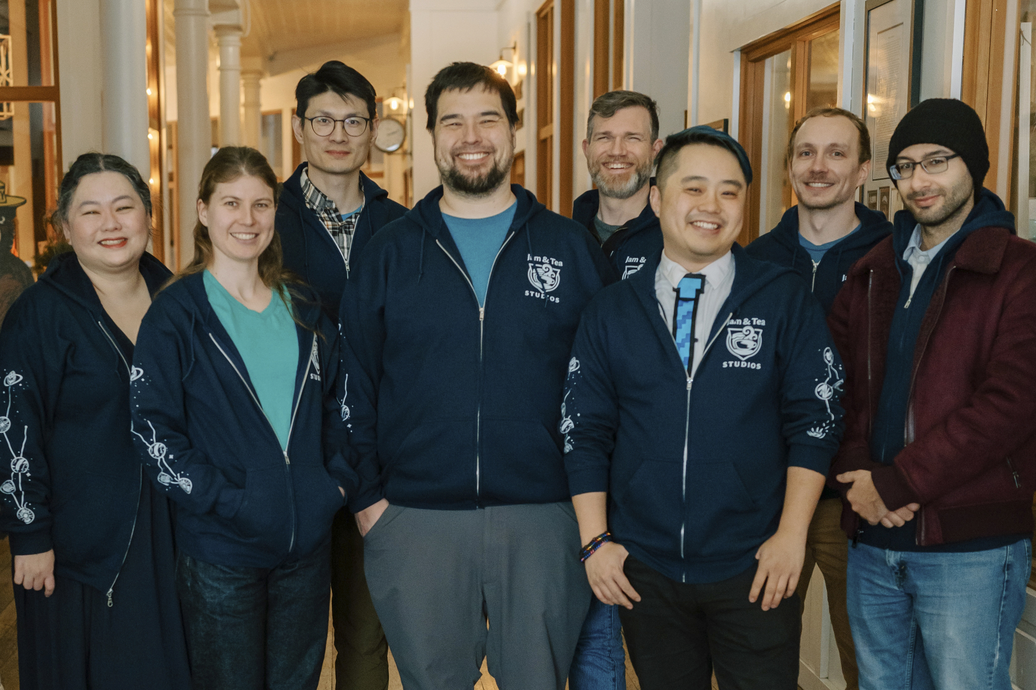 Jam & Tea Studios founders, left to right, Michael Yichao, center, Carl Kwoh, third from right, and J. Aaron Farr, fourth from right, pose with staff on Jan. 18, 2024, in Roslyn, Wash. (Lutisha Aubrey Photography via AP)