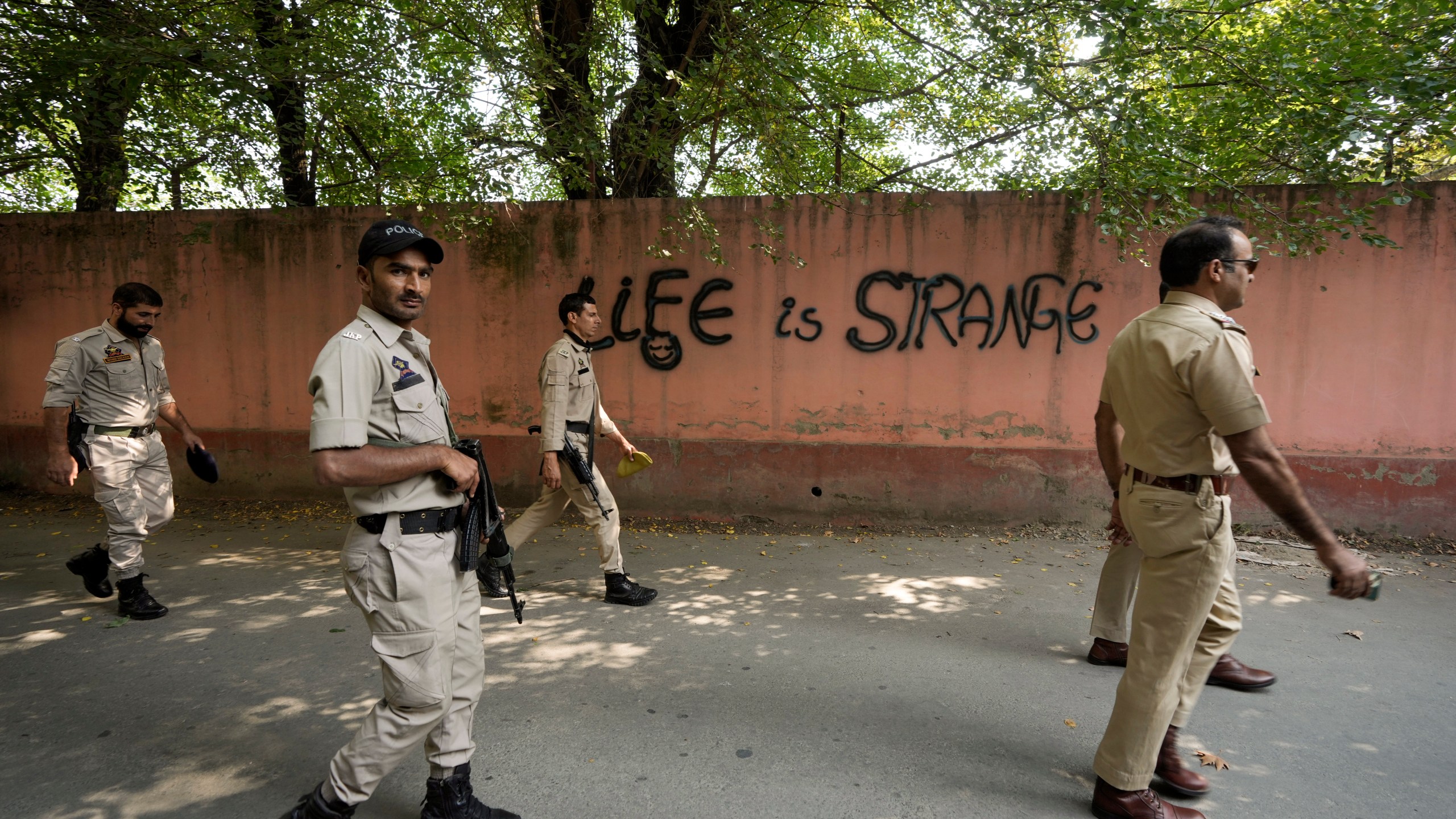 Indian policemen patrol as they guard near a venue for distribution of election material, ahead of the second phase of voting for choosing a local government in Indian-controlled Kashmir, in Srinagar, Tuesday, Sept. 24 , 2024. (AP Photo/Mukhtar Khan)