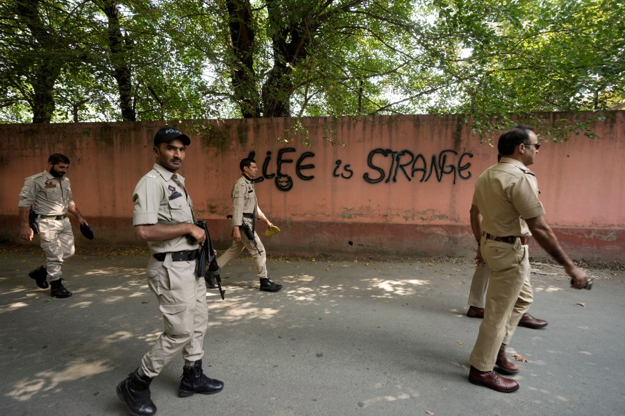 Indian policemen patrol as they guard near a venue for distribution of election material, ahead of the second phase of voting for choosing a local government in Indian-controlled Kashmir, in Srinagar, Tuesday, Sept. 24 , 2024. (AP Photo/Mukhtar Khan)