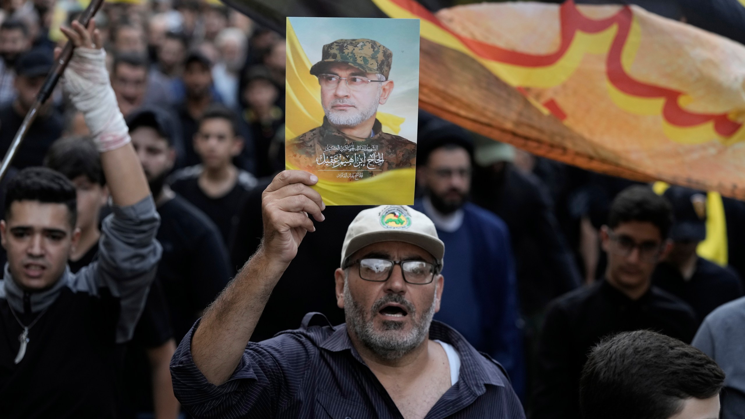 Hezbollah supporters carry pictures of Hezbollah commander Ibrahim Akil during his funeral procession in Beirut's southern suburb, Sunday, Sept. 22, 2024. (AP Photo/Bilal Hussein)