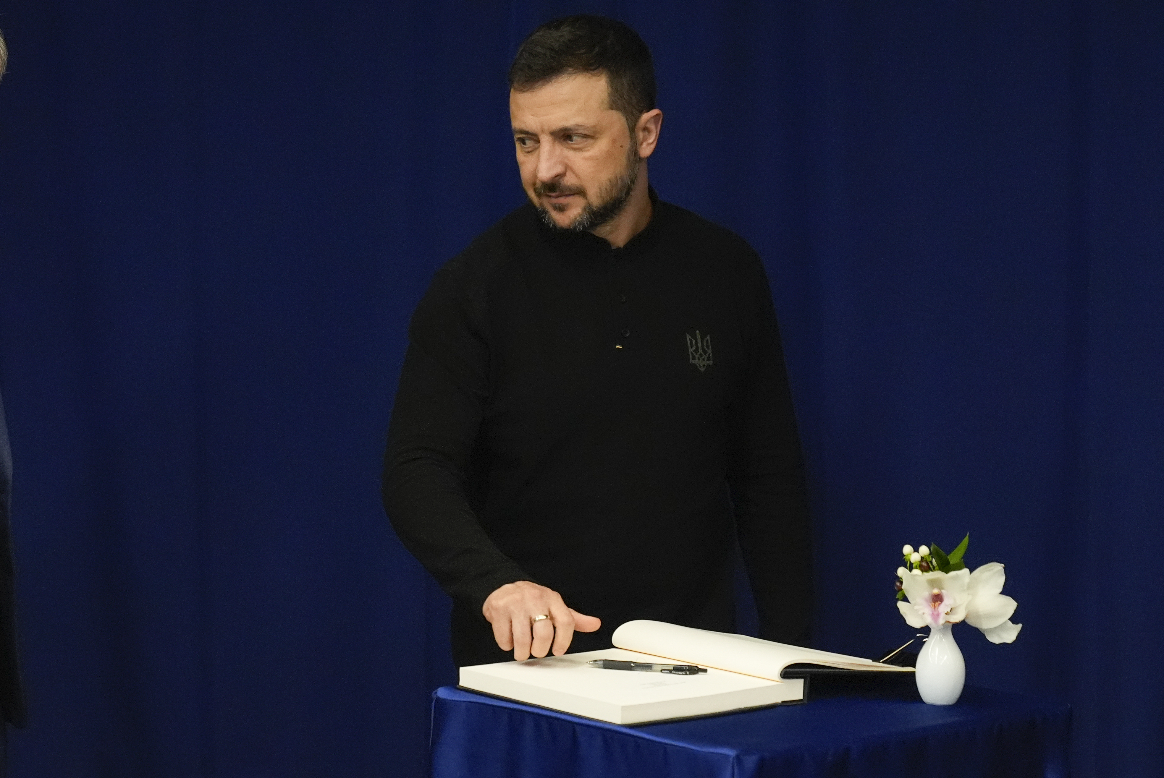 Ukraine President Volodymyr Zelenskyy, signs a guest book before his meeting with United Nations Secretary-General Antonio Guterres, Wednesday, Sept. 25, 2024 at U.N. headquarters. (AP Photo/Frank Franklin II)