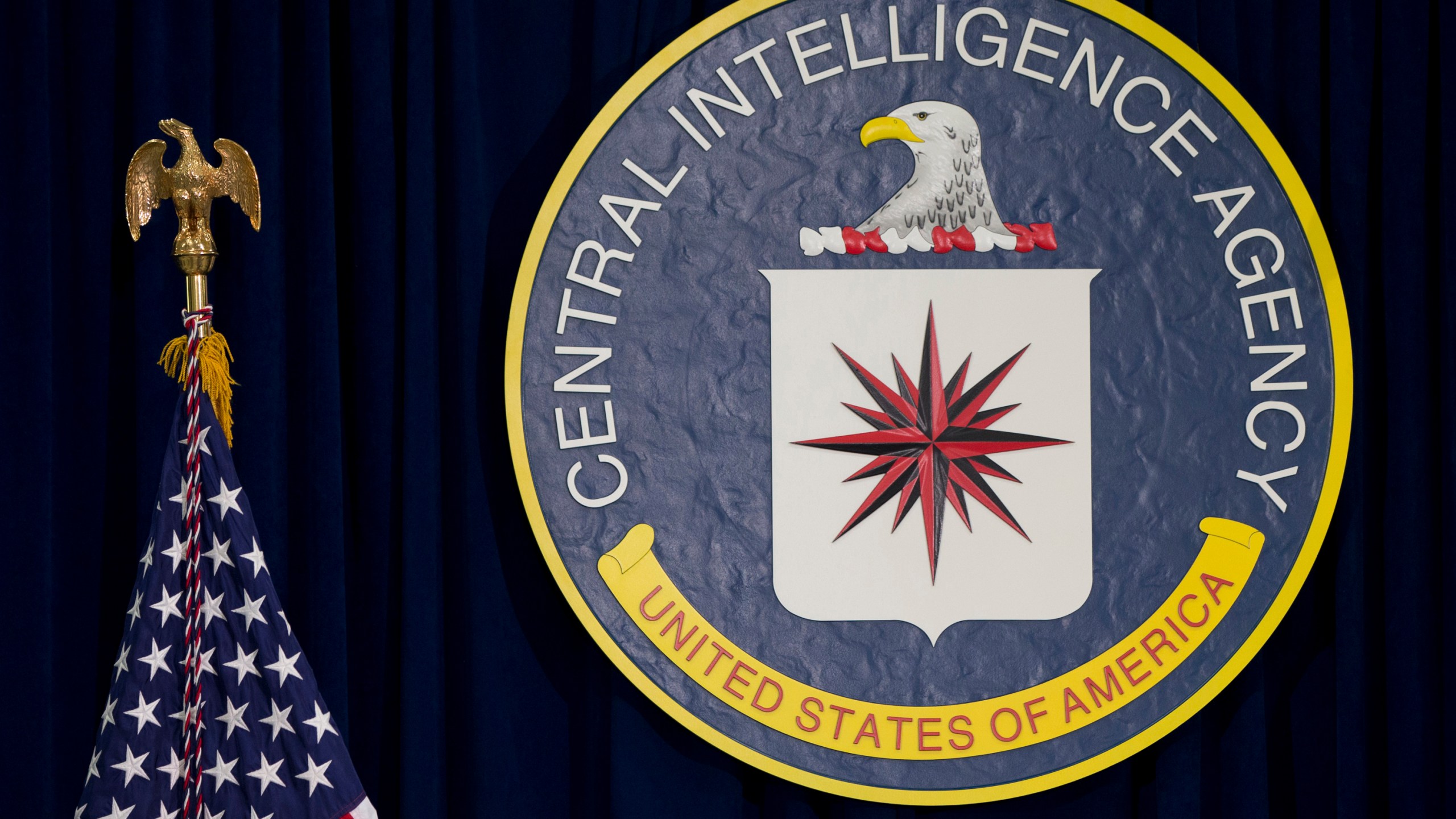 FILE - The seal of the Central Intelligence Agency stands next to a U.S. flag at CIA headquarters in Langley, Va. (AP Photo/Carolyn Kaster, File)