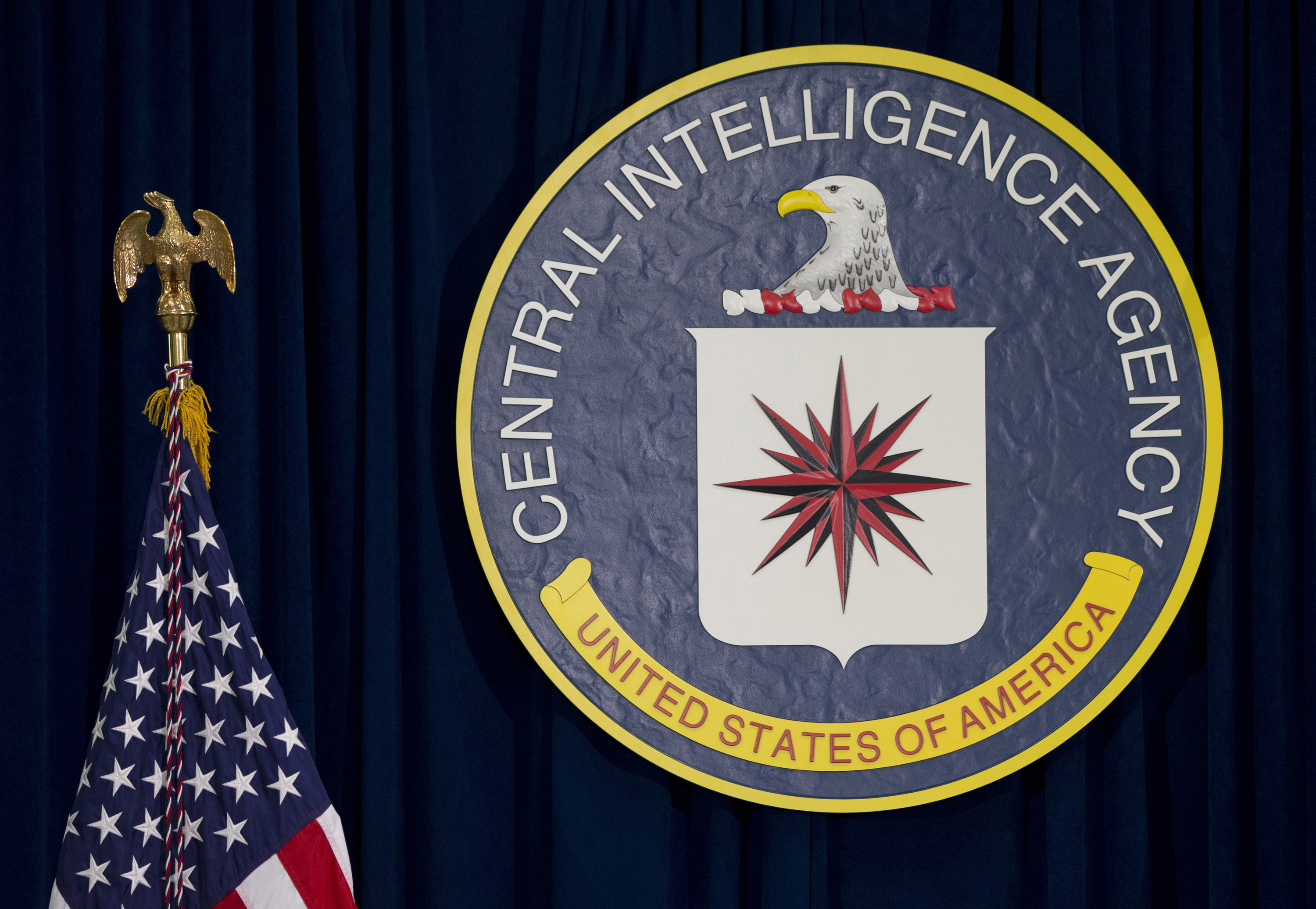 FILE - The seal of the Central Intelligence Agency stands next to a U.S. flag at CIA headquarters in Langley, Va. (AP Photo/Carolyn Kaster, File)