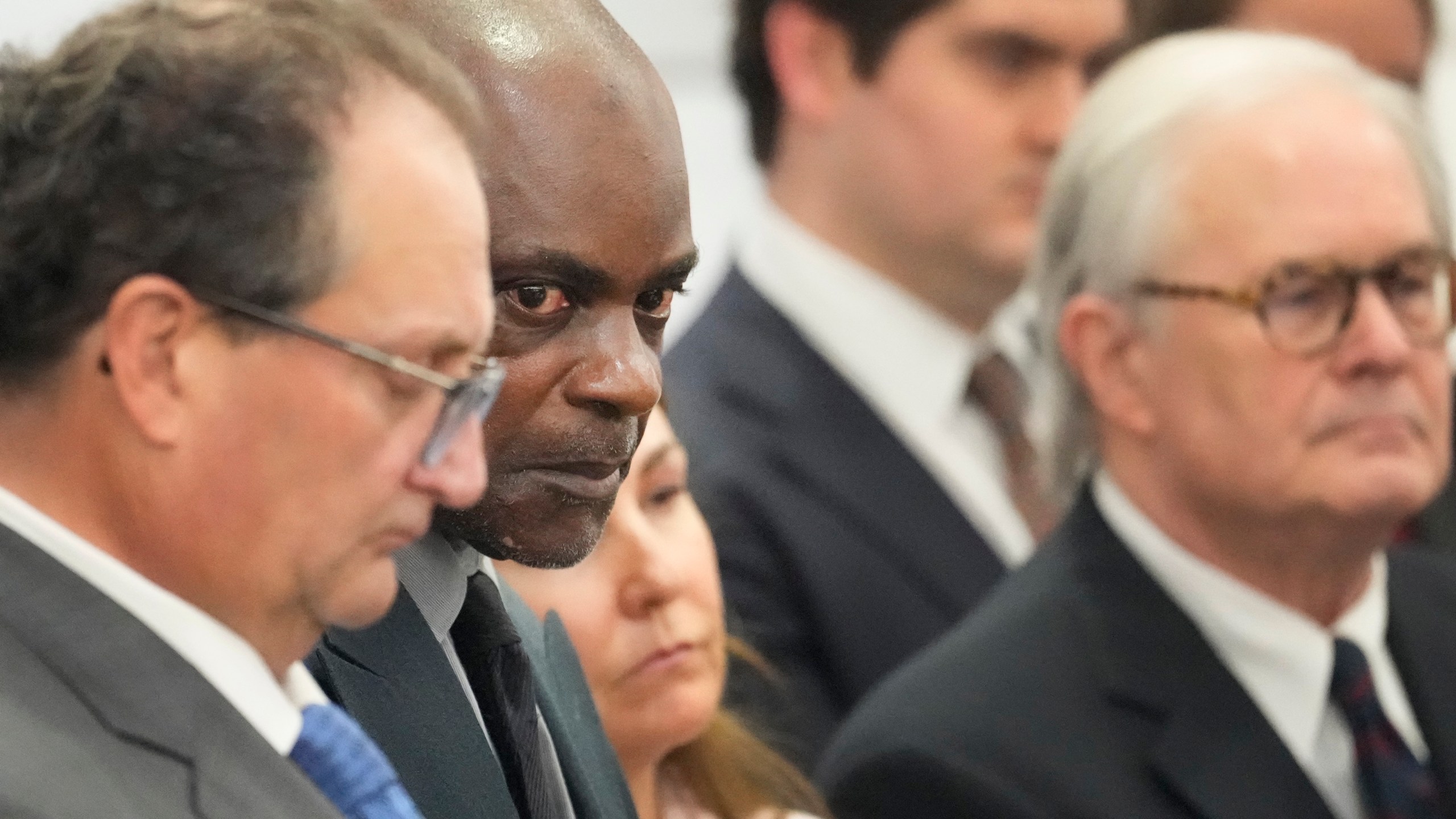 Former Houston police officer Gerald Goines, second from left, stands with his defense attorneys Reagan Wynn, left, Nicole DeBorde Hochglaube, center, and Mac Secrest, right, at the Harris County Criminal courthouse after he was found guilty Wednesday, Sept. 25, 2024, in Houston. (Melissa Phillip/Houston Chronicle via AP)