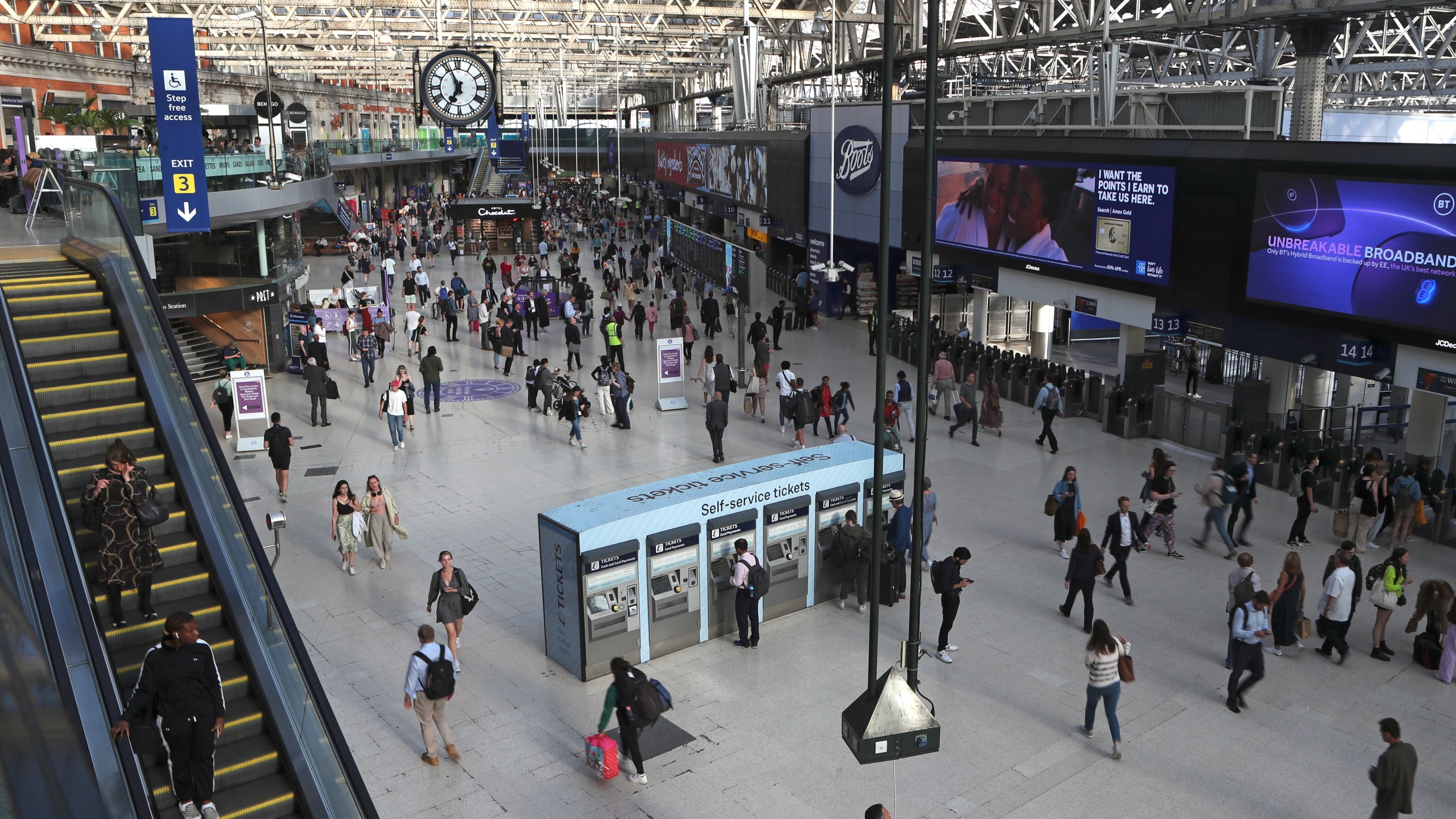 FILE -Commuters walk inside Waterloo station in London, June 20, 2022.(AP Photo/Tony Hicks), File)