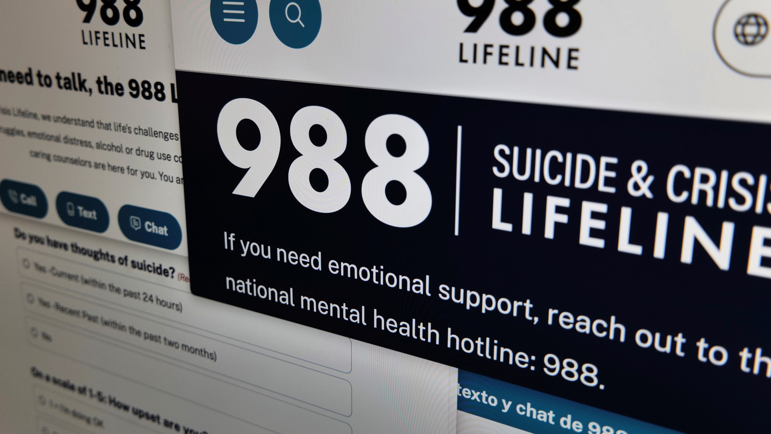 Pages from the U.S. 988 Suicide & Crisis Lifeline website are arranged for a photograph in New York on Tuesday, Sept. 24, 2024. (AP Photo/Patrick Sison)