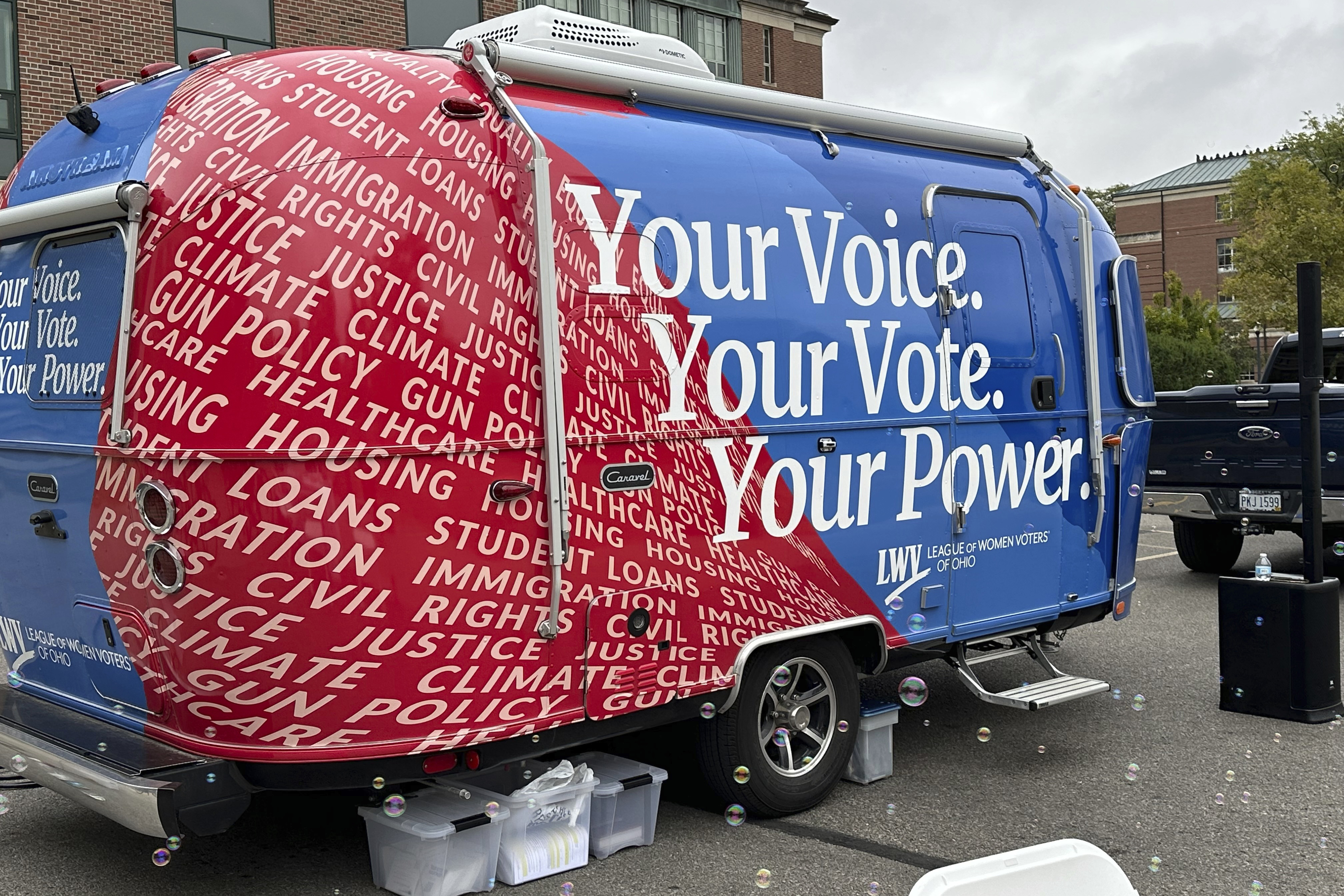 A 19-foot Airstream Caravel on loan to the League of Women Voters of Ohio visits the main campus of the Ohio State University in Columbus, Ohio, Thursday, Sept. 26, 2024, as the group works to register and engage student voters. (AP Photo/Julie Carr Smyth)