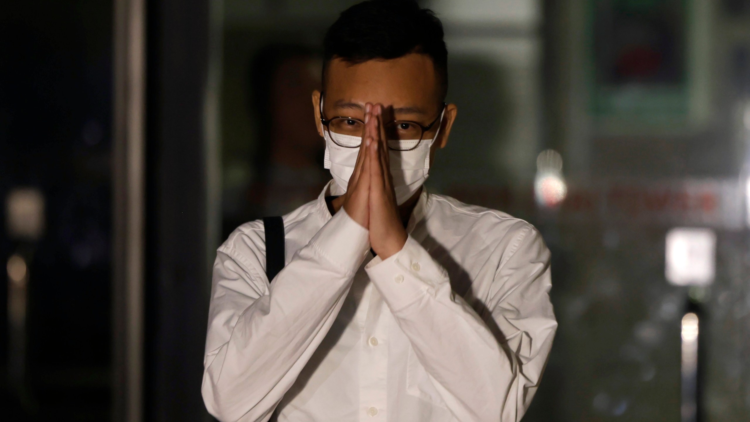 Patrick Lam, the former acting editor-in-chief of Hong Kong's now shuttered pro-democracy news outlet Stand News gestures to the gathered media as he leaves the Wanchai District Court after the final sentencing of Stand News sedition case in Wan Chai district court in Hong Kong on Thursday, Sept. 26, 2024. (AP Photo/May James)