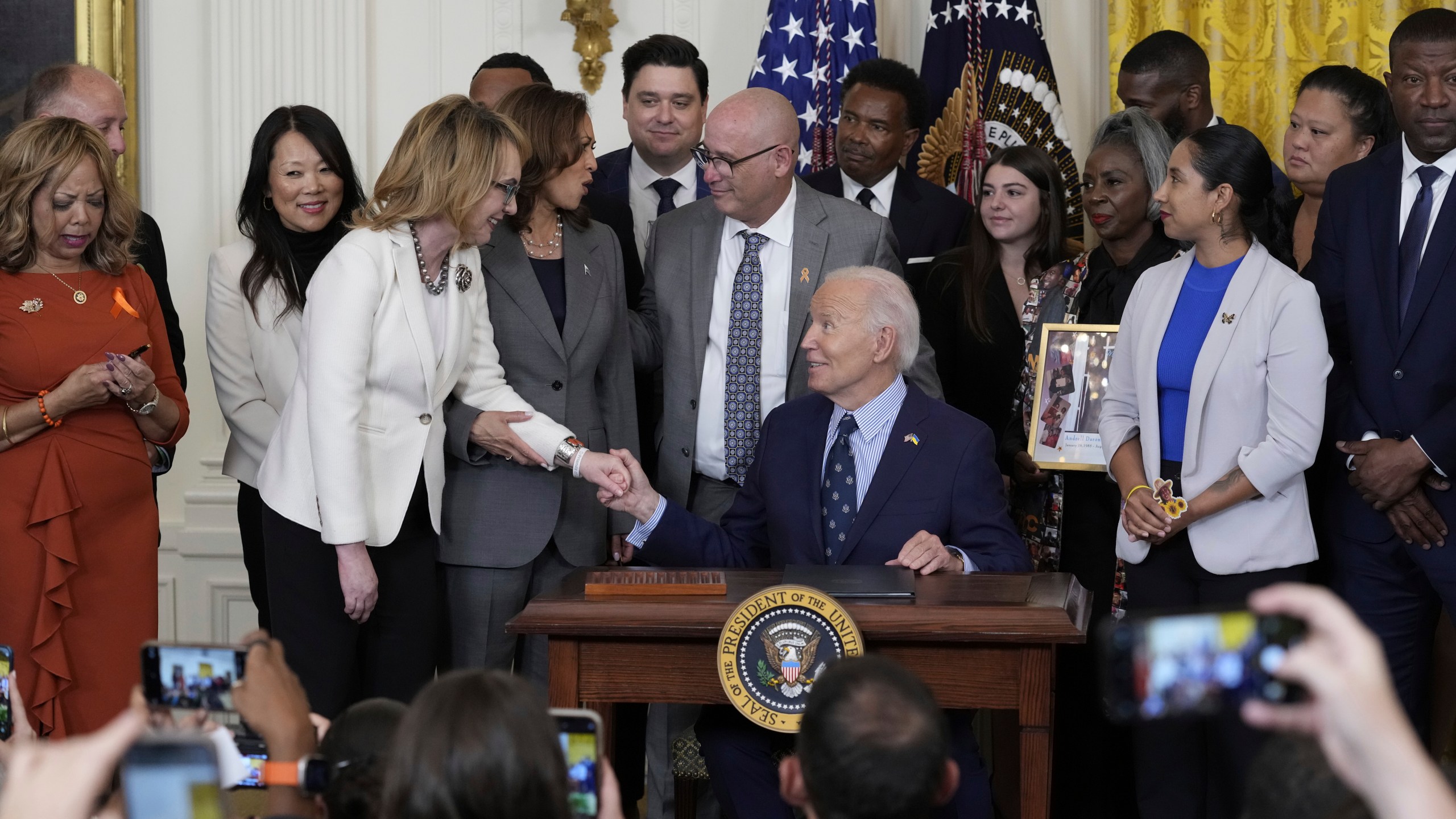 Former Rep. Gabby Giffords speaks with President Joe Biden during an event with Vice President Kamala Harris and others in the East Room of the White House in Washington, Thursday, Sept. 26, 2024, on gun violence in the United States. (AP Photo/Susan Walsh)