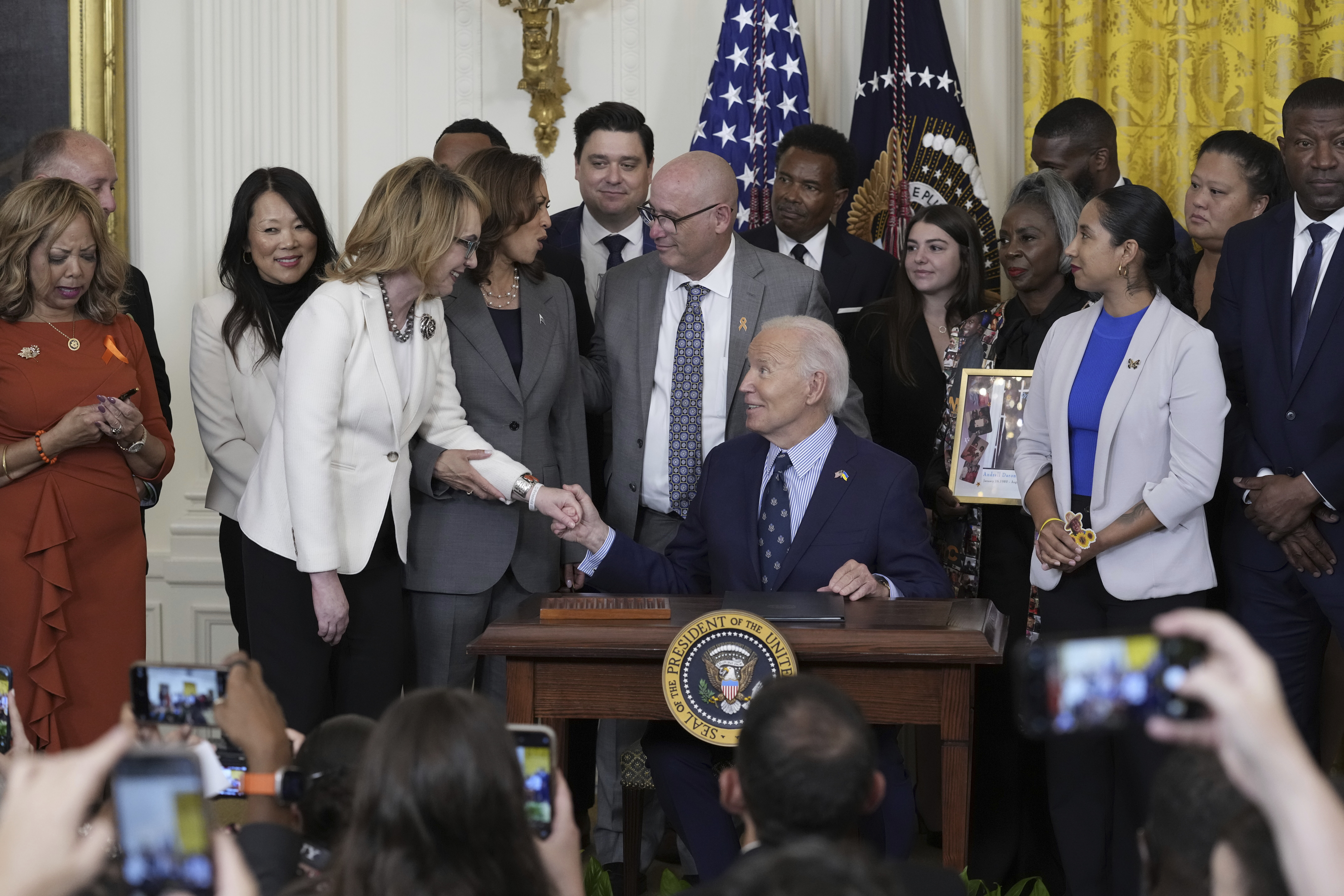 Former Rep. Gabby Giffords speaks with President Joe Biden during an event with Vice President Kamala Harris and others in the East Room of the White House in Washington, Thursday, Sept. 26, 2024, on gun violence in the United States. (AP Photo/Susan Walsh)