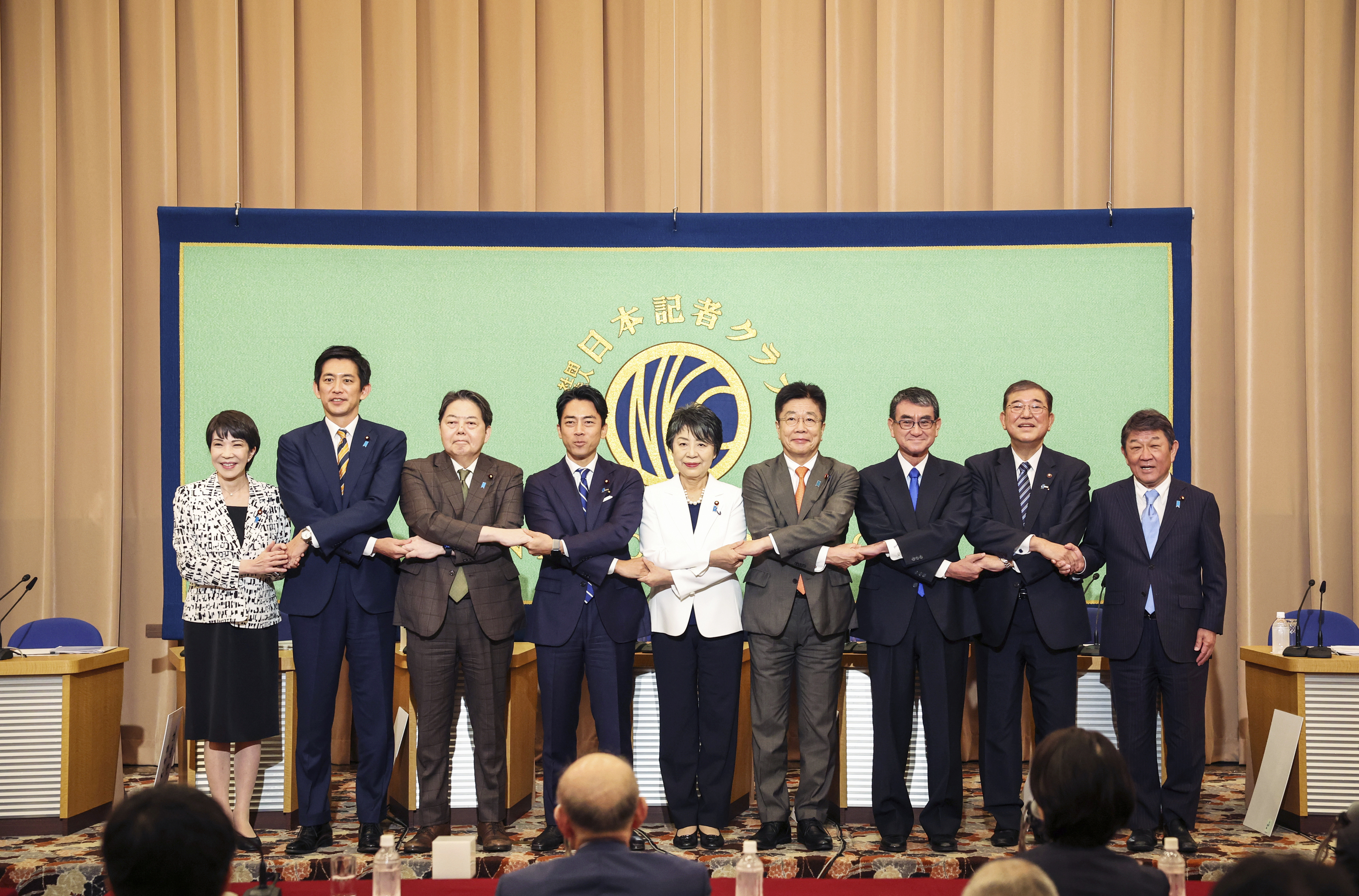 FILE - Candidates for Japan's ruling Liberal Democratic Party's (LDP) presidential election pose for a photo before a debate at the Japan National Press Club in Tokyo, on Sept. 14, 2024. From left are Economic Security Minister Sanae Takaichi, former Economic Security Minister Takayuki Kobayashi, Chief Cabinet Secretary Yoshimasa Hayashi, former Environment Minister Shinjiro Koizumi, Foreign Minister Yoko Kamikawa, former Chief Cabinet Secretary Katsunobu Kato, Digital Minister Taro Kono, former Defense Minister Shigeru Ishiba and Liberal Democratic Party Secretary General Toshimitsu Motegi. (Takashi Aoyama/Pool Photo via AP, File)