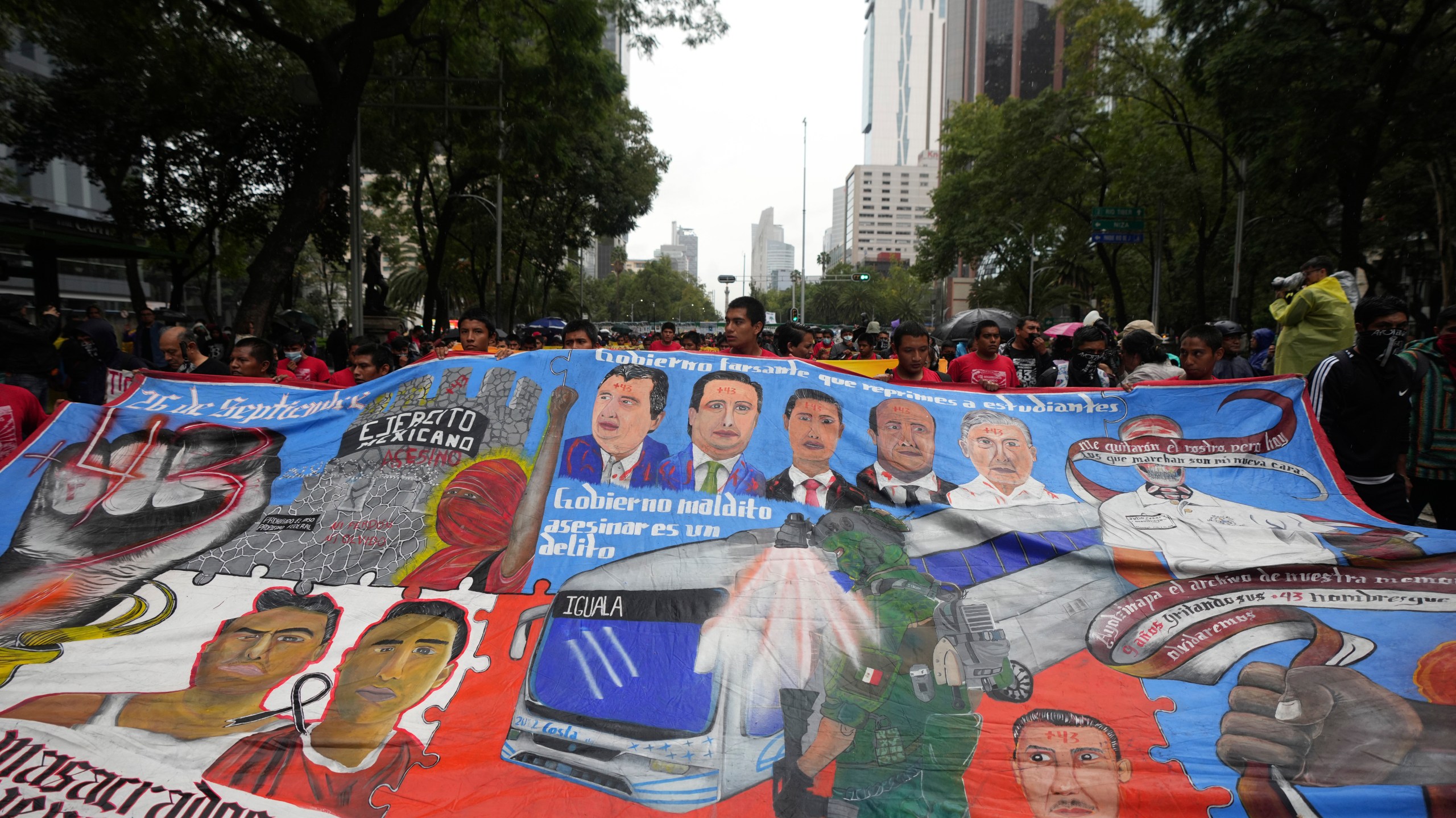 Families and friends take part in a demonstration marking the 10-year anniversary of the disappearance of 43 students from an Ayotzinapa rural teacher's college, in Mexico City, Thursday, Sept. 26, 2024. (AP Photo/Fernando Llano)