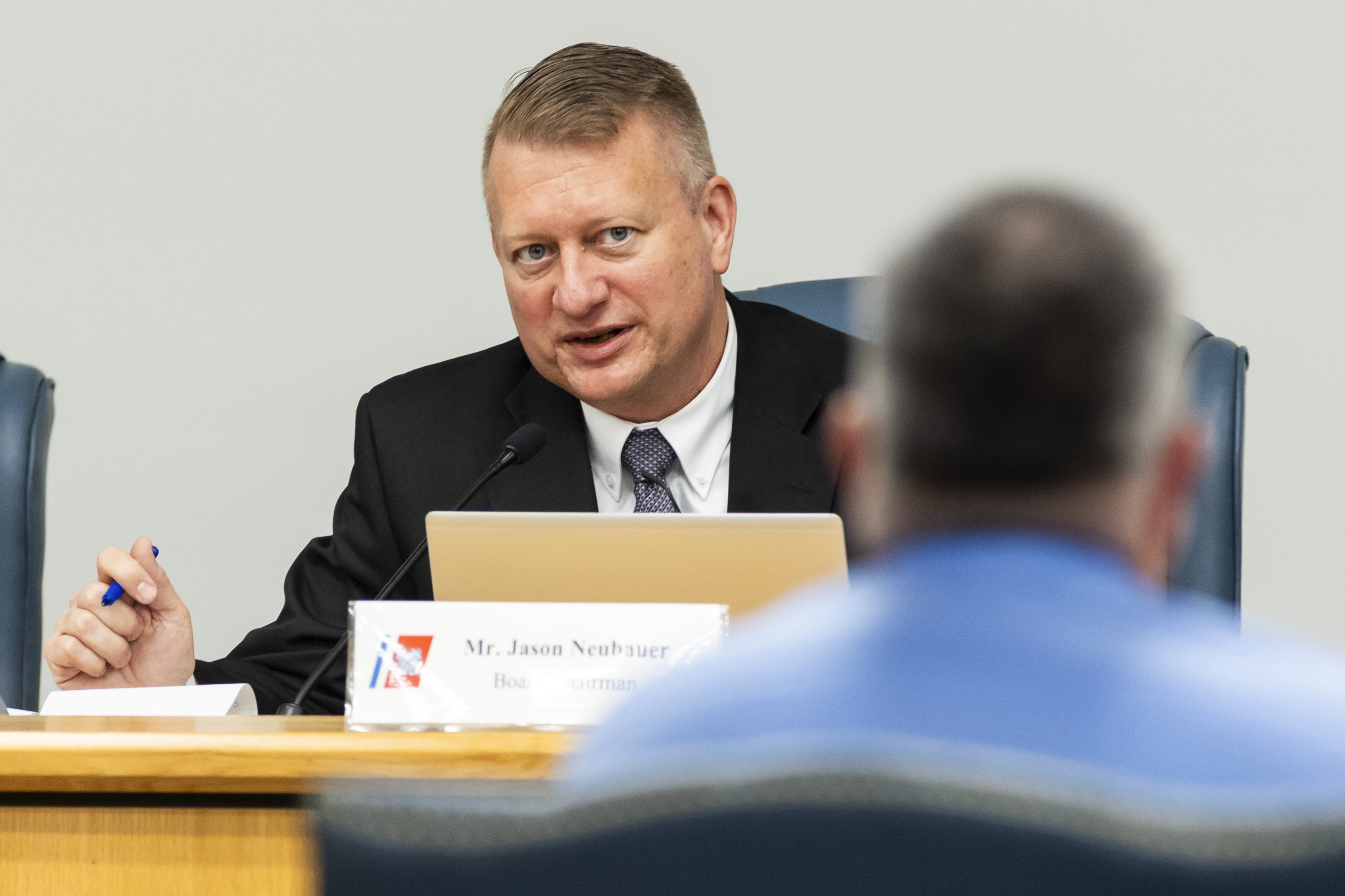 Jason Neubauer, at left, board chairman, questions Matthew McCoy, a former OceanGate employee, during the final day of the Coast Guard investigatory hearing on the causes of the implosion of an experimental submersible headed for the wreck of the Titanic, Friday, Sept. 27, 2024, in North Charleston, S.C. (AP Photo/Mic Smith)