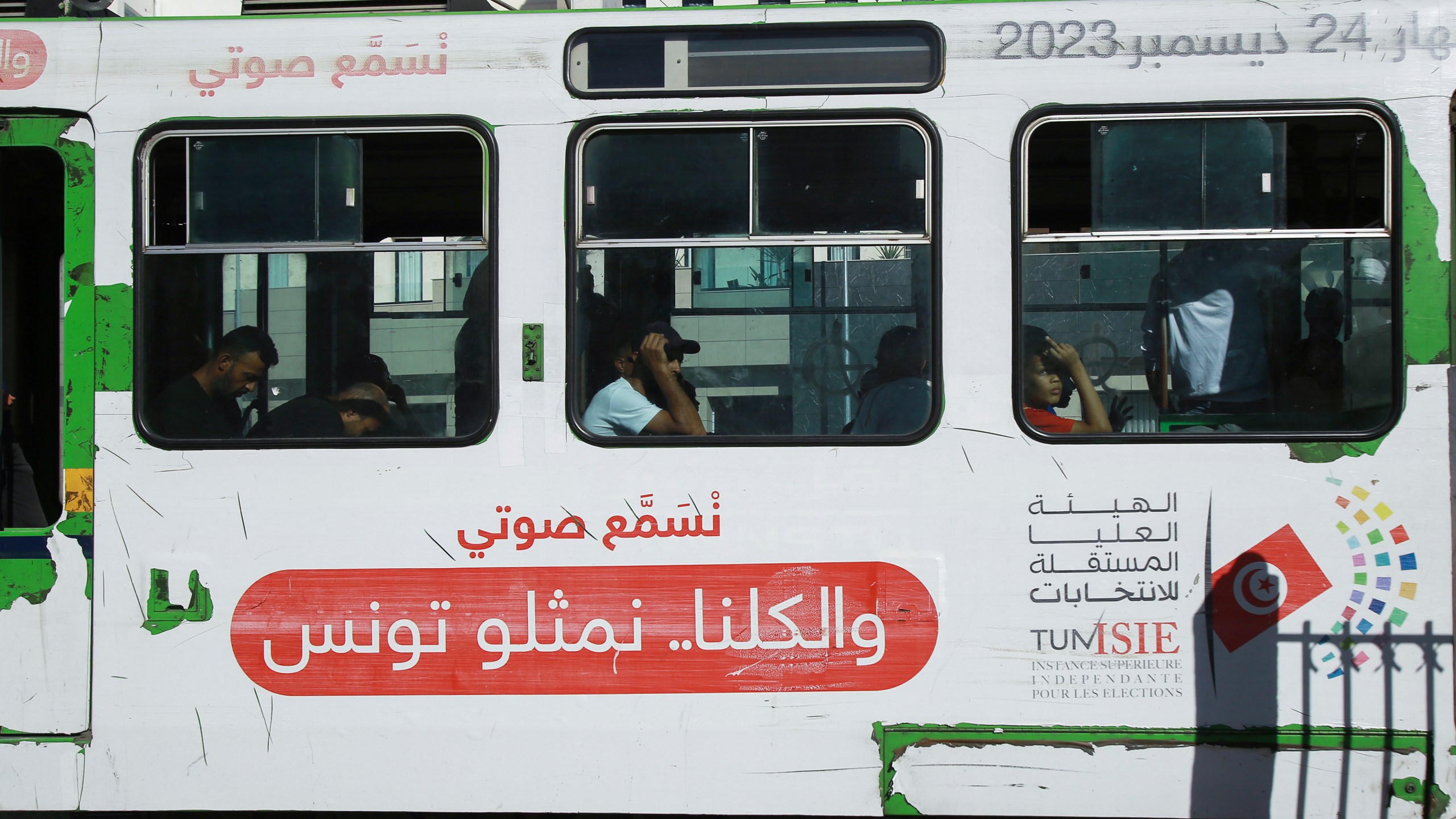 People ride the Metro as it shows banners of the Election Committee, ahead of the upcoming presidential elections, in the capital Tunis, Tunisia, Thursday, Sept. 26, 2024. (AP Photo/Anis Mili)