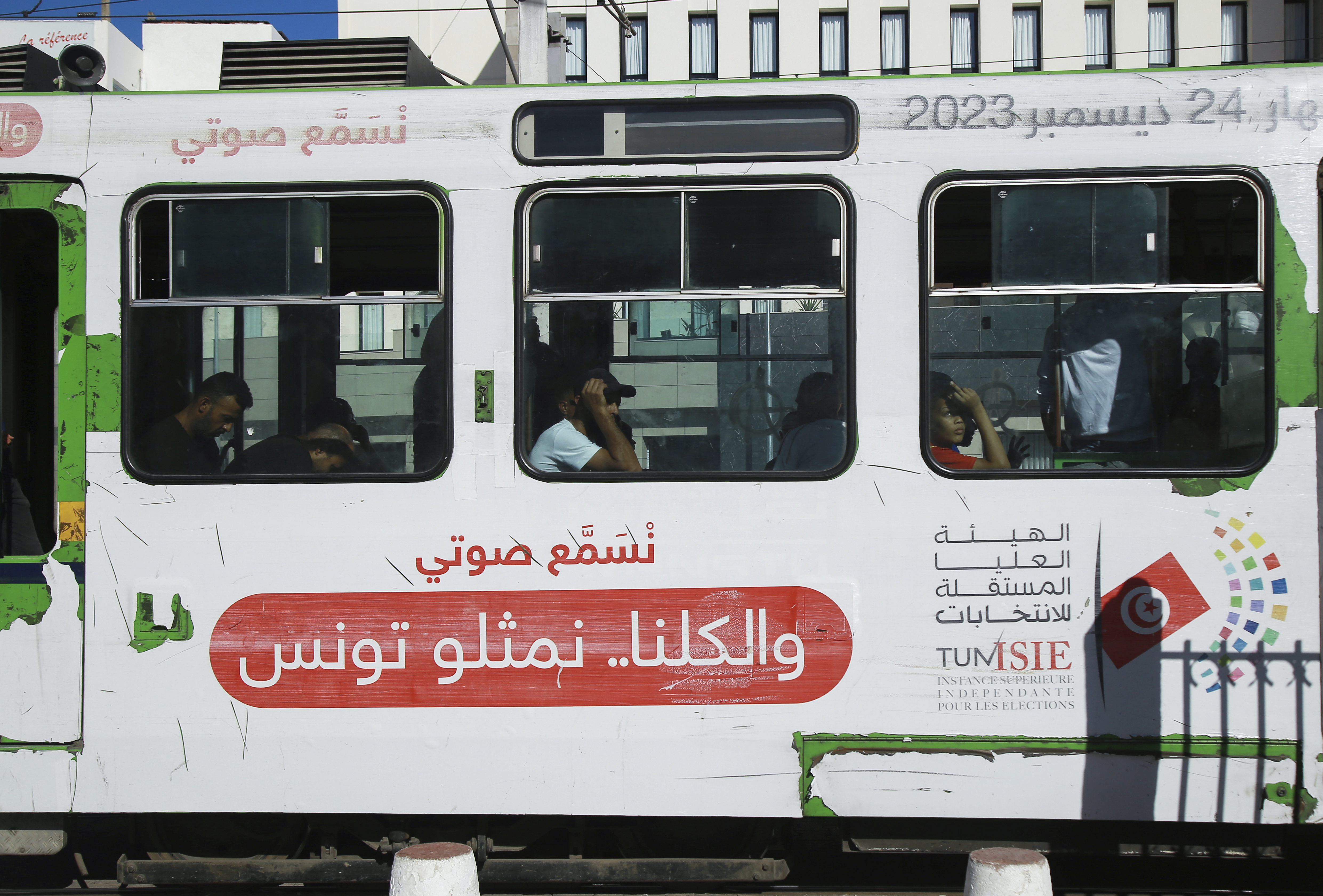 People ride the Metro as it shows banners of the Election Committee, ahead of the upcoming presidential elections, in the capital Tunis, Tunisia, Thursday, Sept. 26, 2024. (AP Photo/Anis Mili)