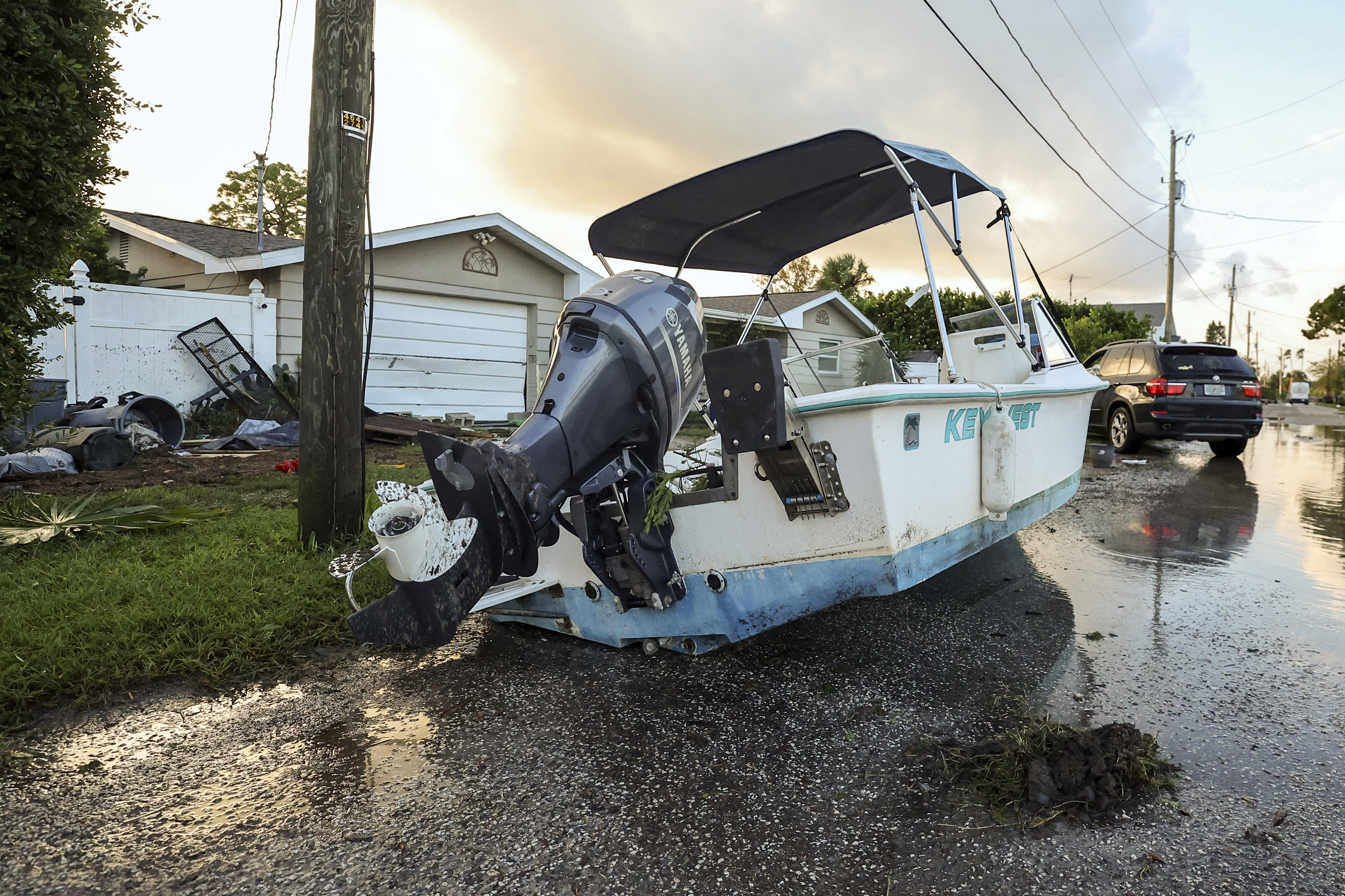 A boat rests on a street after being relocated during flooding caused by Hurricane Helene Friday, Sept. 27, 2024, in Hudson, Fla. (AP Photo/Mike Carlson)