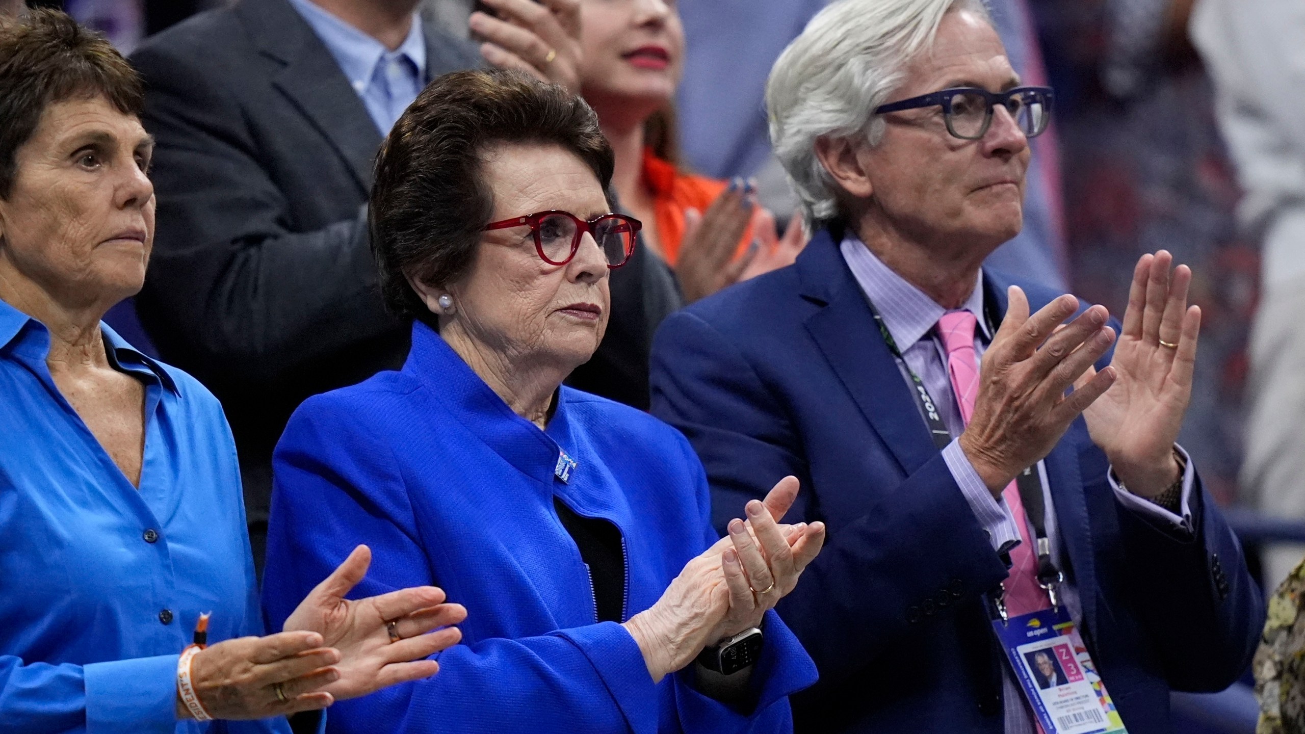 Billie Jean King, center, her wife Ilana Kloss and USTA president Brian Hainline, arrives for the women's singles final of the U.S. Open tennis championships between Aryna Sabalenka, of Belarus, and Jessica Pegula, of the United States, Saturday, Sept. 7, 2024, in New York. (AP Photo/Frank Franklin II)