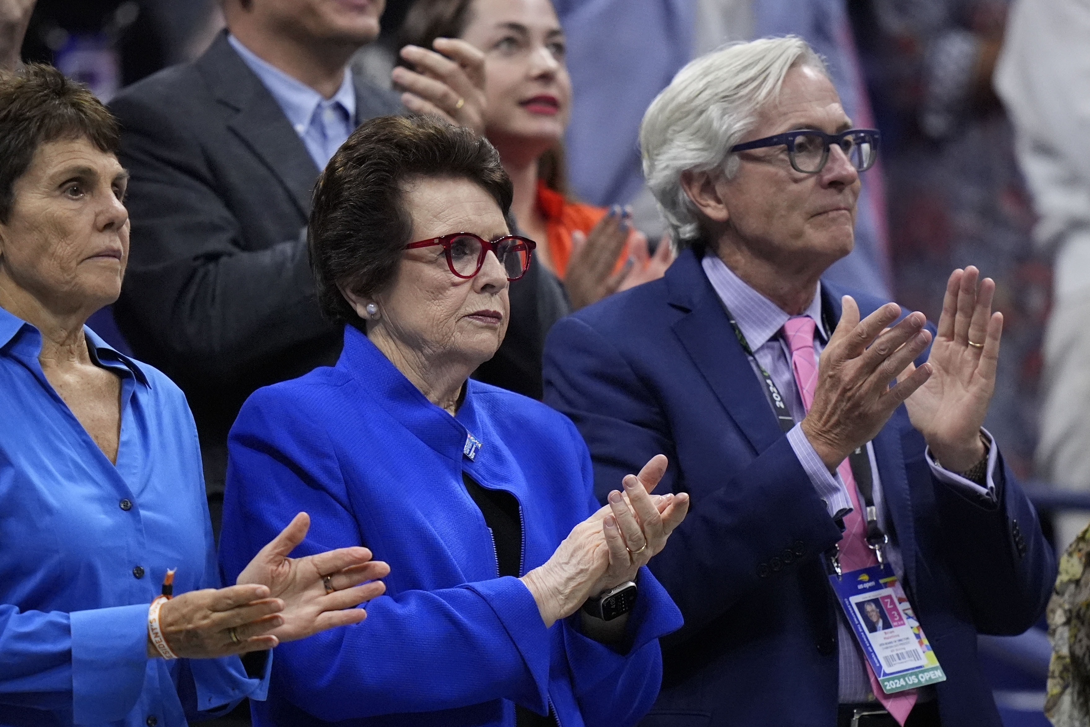 Billie Jean King, center, her wife Ilana Kloss and USTA president Brian Hainline, arrives for the women's singles final of the U.S. Open tennis championships between Aryna Sabalenka, of Belarus, and Jessica Pegula, of the United States, Saturday, Sept. 7, 2024, in New York. (AP Photo/Frank Franklin II)