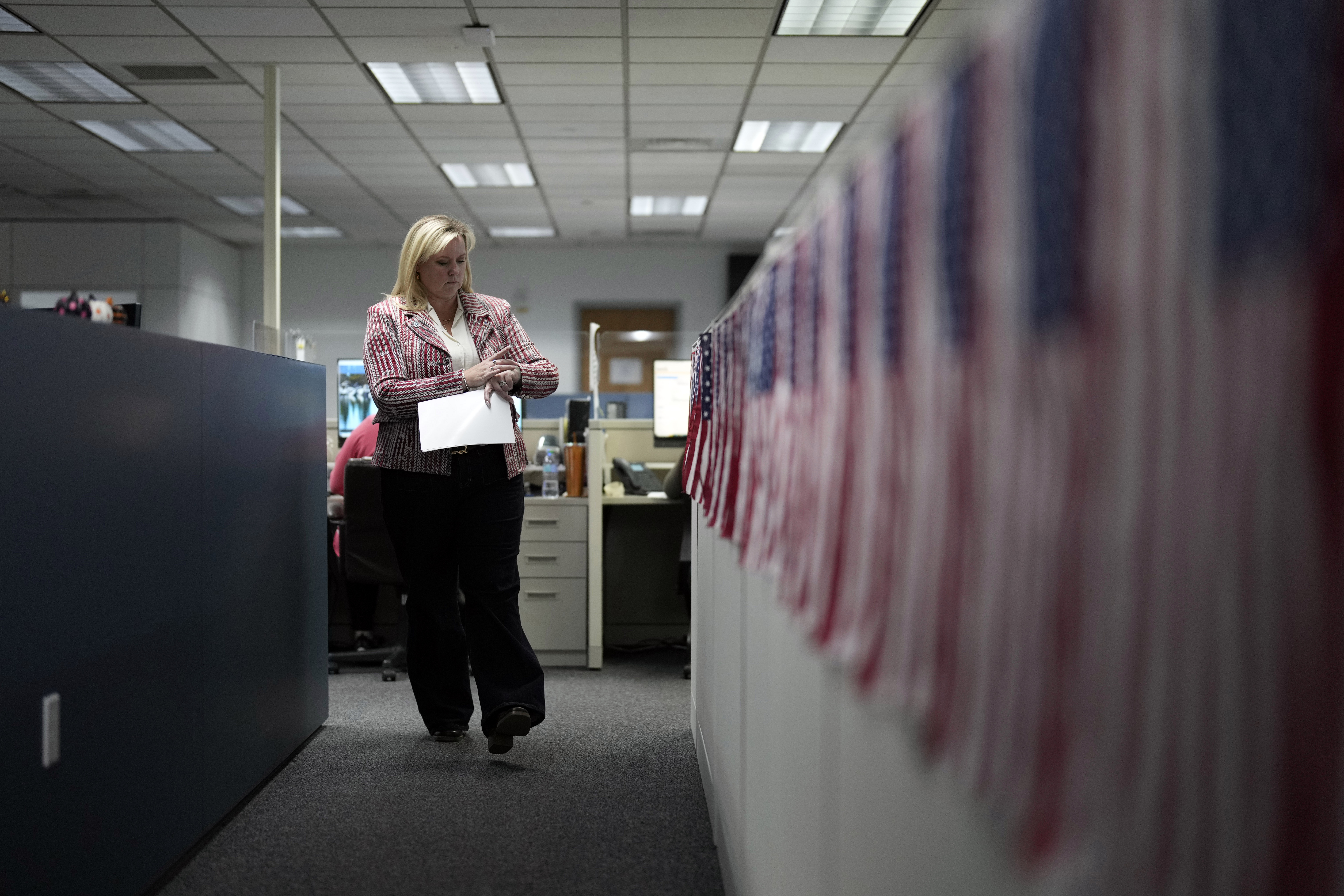 Cari-Ann Burgess, interim registrar of voters for Washoe County, Nev., walks through the office Sept. 20, 2024, in Reno, Nev. (AP Photo/John Locher)