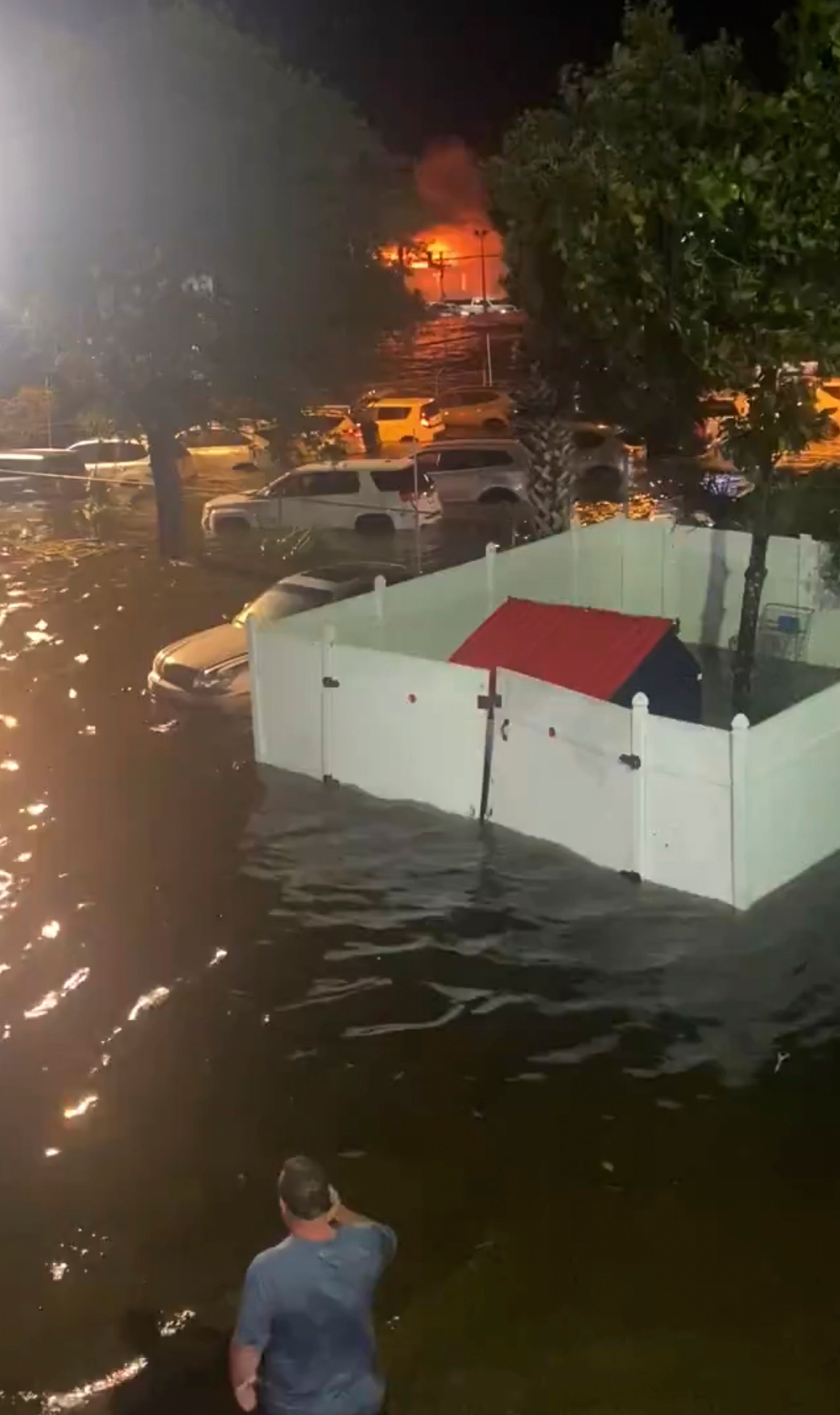 A person looks over a flooded street due to Hurricane Helene late Thursday, Sept. 26, 2024 in New Port Richey, Fla. (Danielle Molisee via AP)