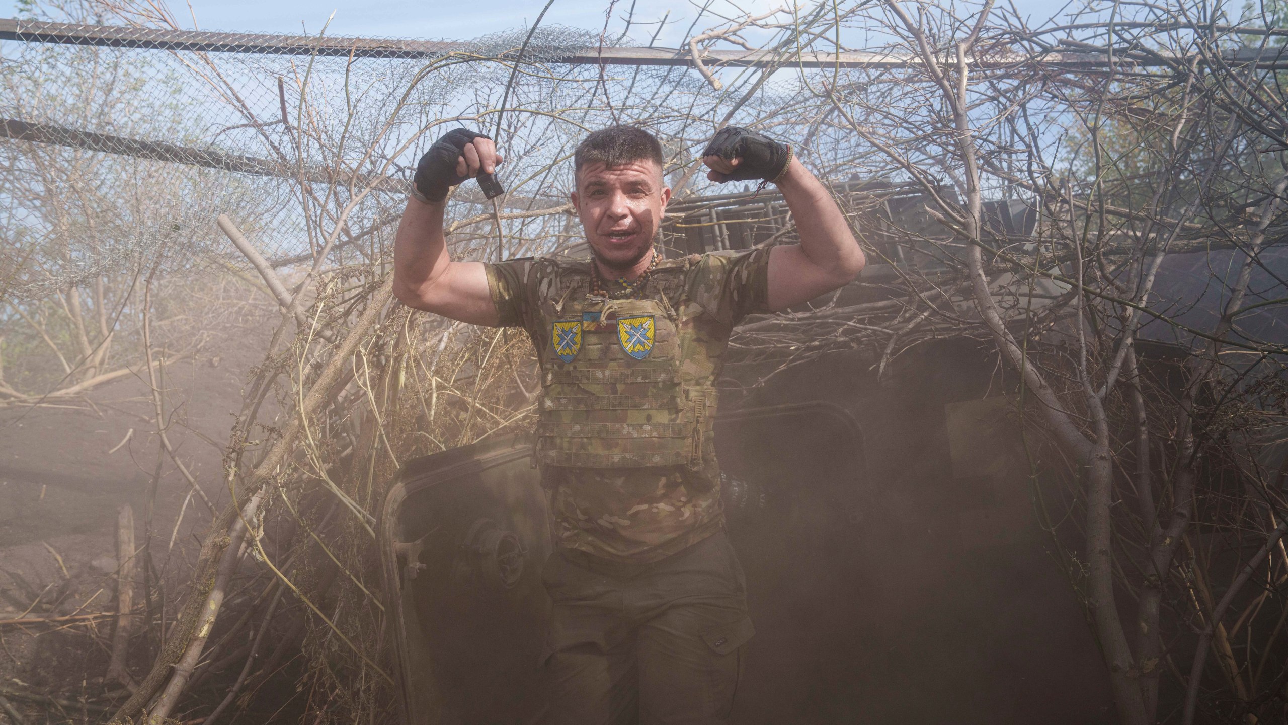 Ukrainian serviceman of 56th brigade reacts near self-propelled artillery vehicle after firing towards Russian positions at the frontline on Chasiv Yar direction, Donetsk region, Ukraine, Sept. 27, 2024. (AP Photo/Evgeniy Maloletka)