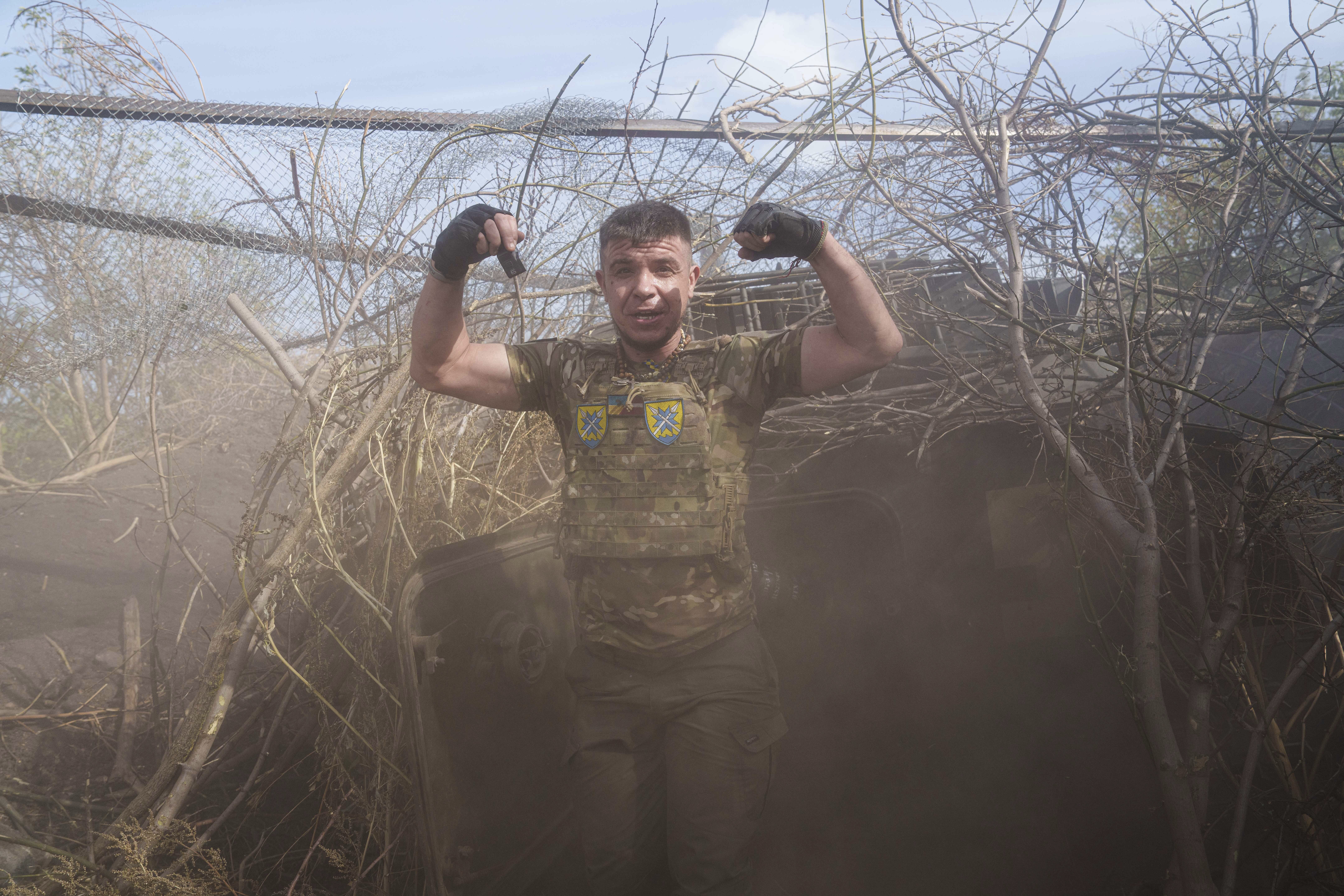 Ukrainian serviceman of 56th brigade reacts near self-propelled artillery vehicle after firing towards Russian positions at the frontline on Chasiv Yar direction, Donetsk region, Ukraine, Sept. 27, 2024. (AP Photo/Evgeniy Maloletka)