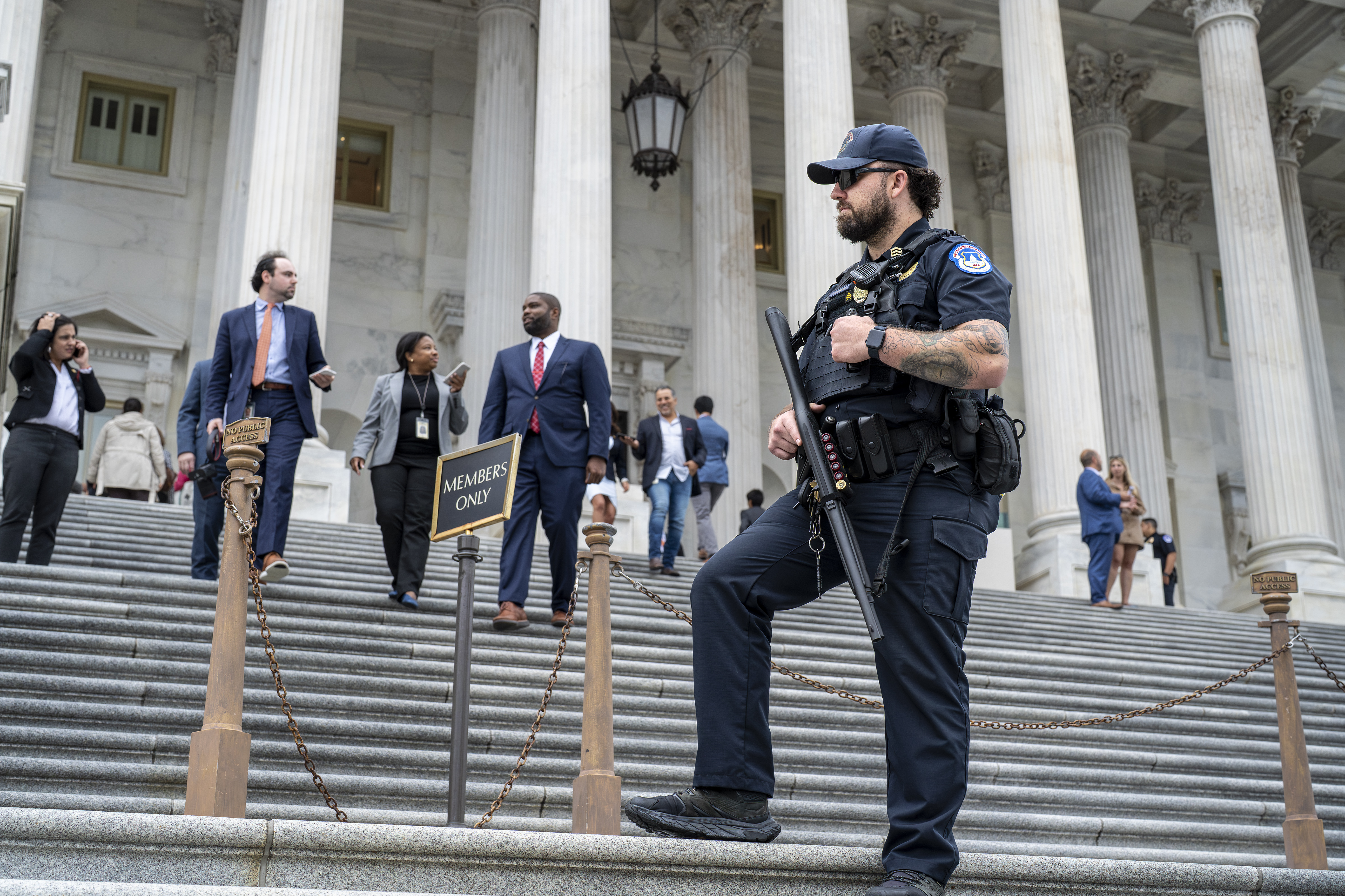 A U.S. Capitol Police officer stands watch as lawmakers leave the House of Representatives after voting on an interim spending bill to avoid a government shutdown next week, at the Capitol in Washington, Wednesday, Sept. 25, 2024. (AP Photo/J. Scott Applewhite)