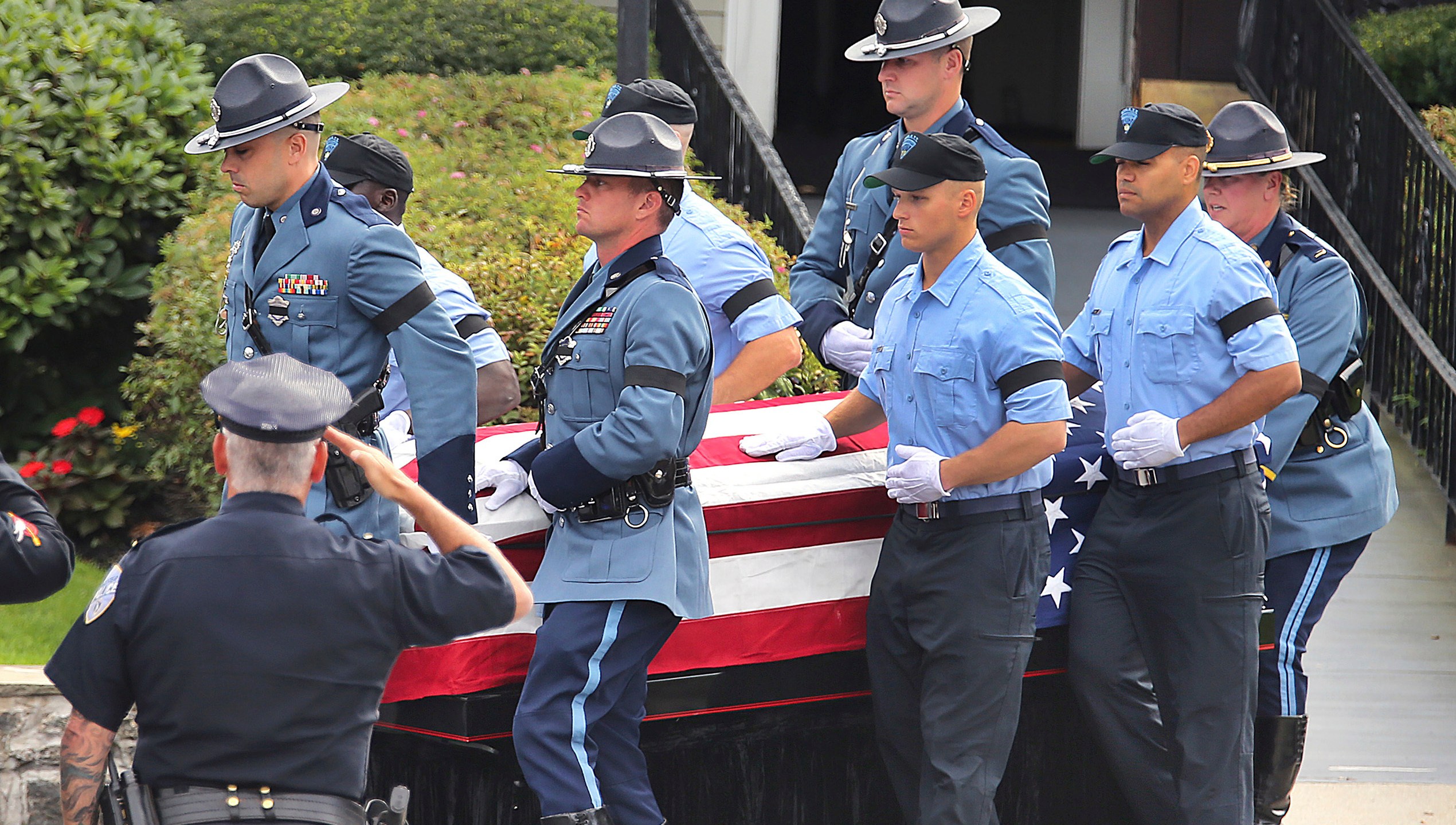 Pallbearers carry the casket of Massachusetts State Police recruit Enrique Delgado-Garcia at the start of his funeral service at the Mercadante Funeral Home in Worcester, Mass., Saturday, Sept. 24, 2024. (John Tlumacki/The Boston Globe via AP)