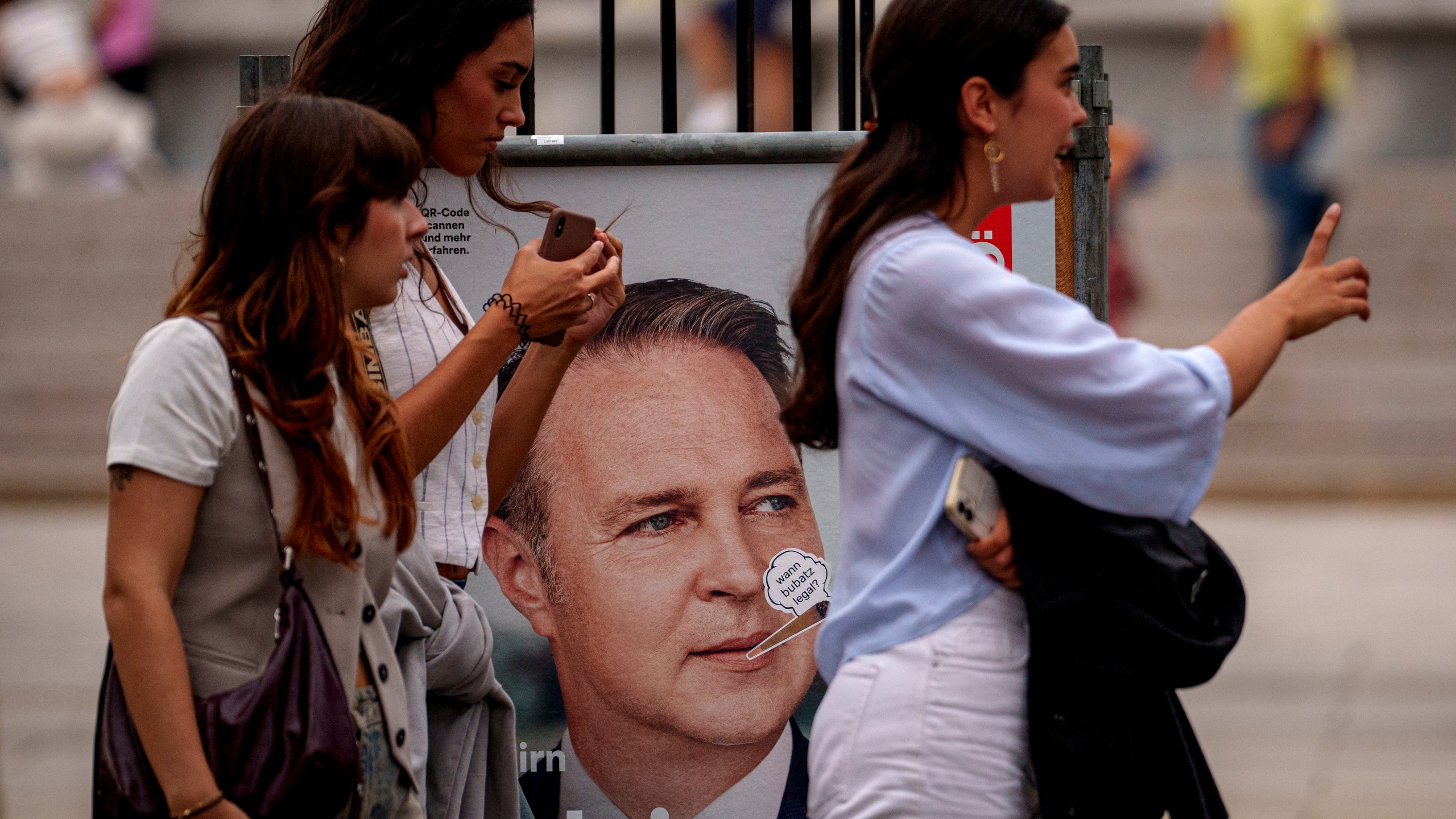 Women walk by posters of the Social Democratic, SPOe Party, showing Andreas Babler, in Vienna, Austria, Thursday, Sept. 26, 2024, ahead of the country's national election which will take place on Sept. 29. (AP Photo/Andreea Alexandru)