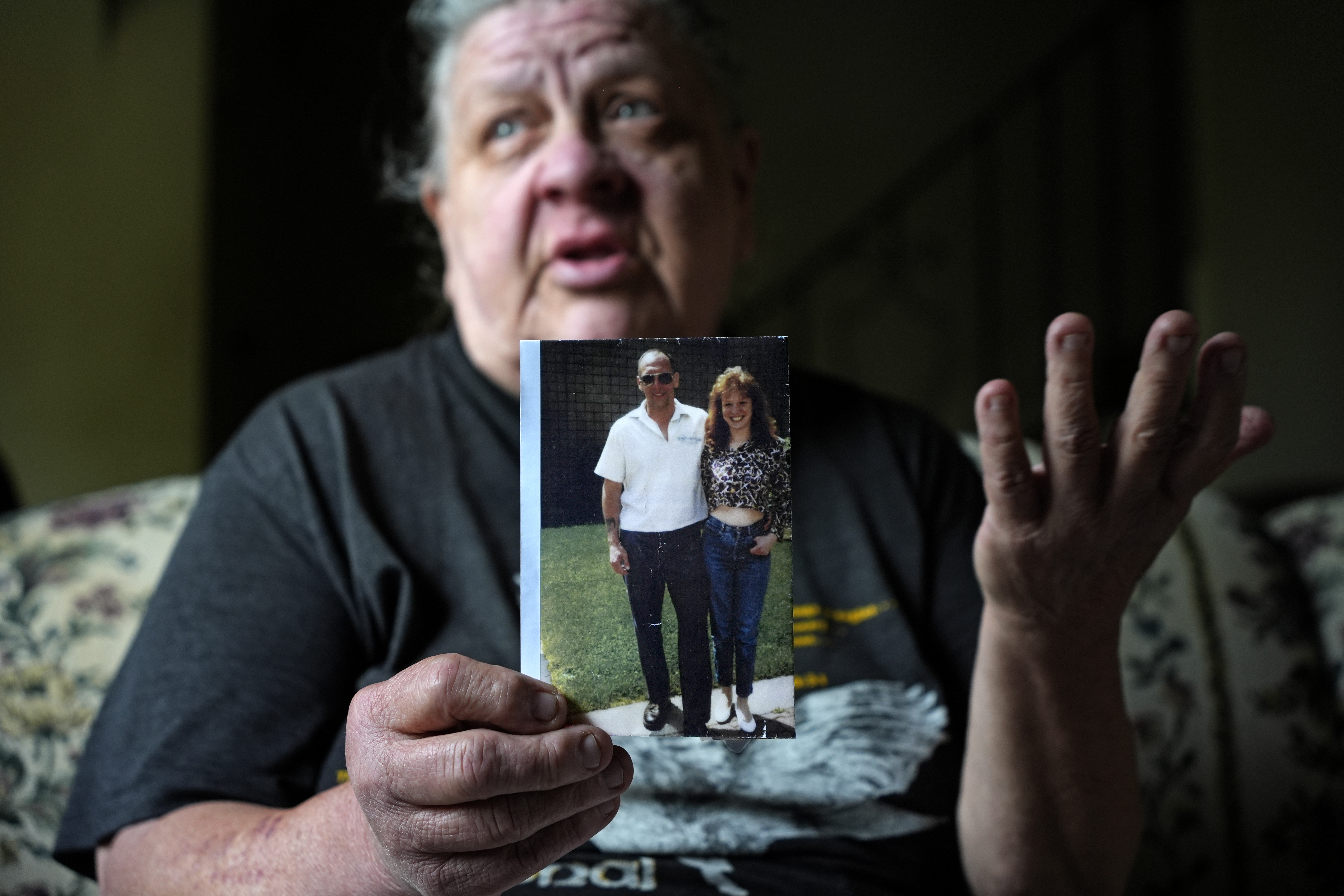 Suzy Patton holds a photo of her brother Steve Szarewicz, who insists he was wrongly convicted of a 1981 murder based on the testimony of four jailhouse informants, in her home in New Kensington, Pa, on Tuesday, April 30, 2024. (AP Photo/Gene J. Puskar)