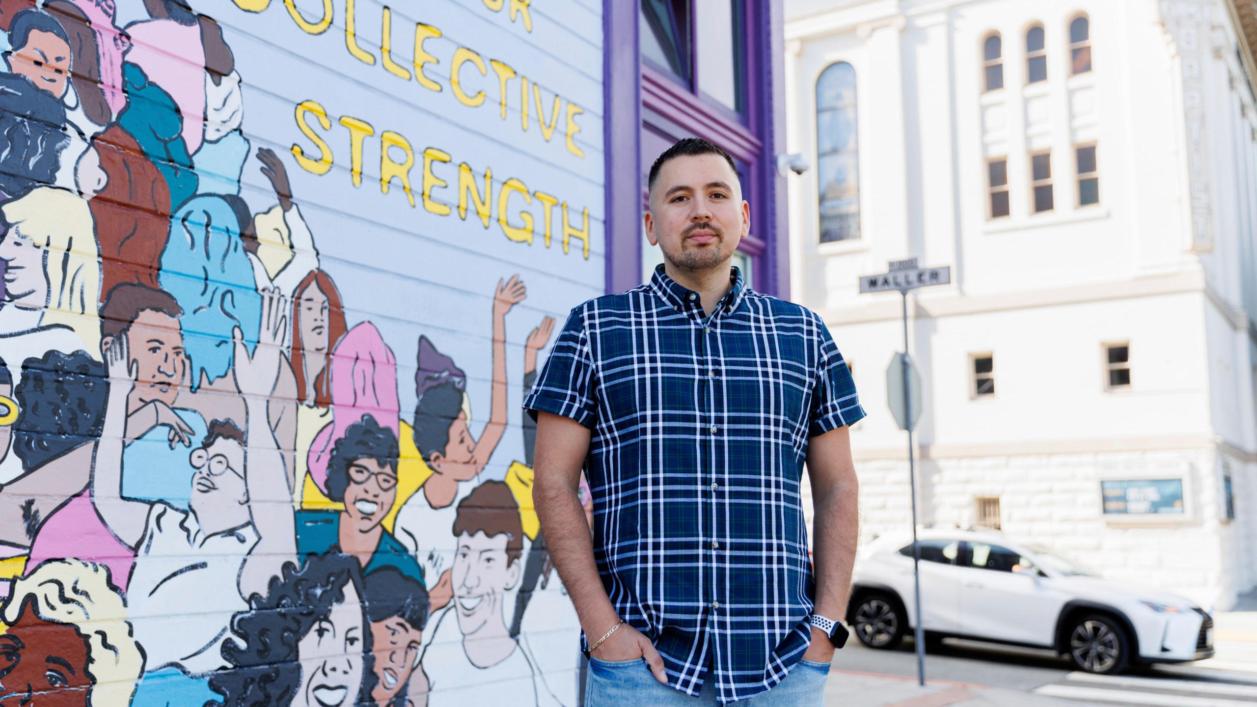 Luis A. Torres stands for a portrait in front of the " Joy is the Fuel" mural by Cuban-American artist Alma Landeta at the SF LGBT Center on Friday, Sept. 20, 2024, in San Francisco. (AP Photo/Juliana Yamada)